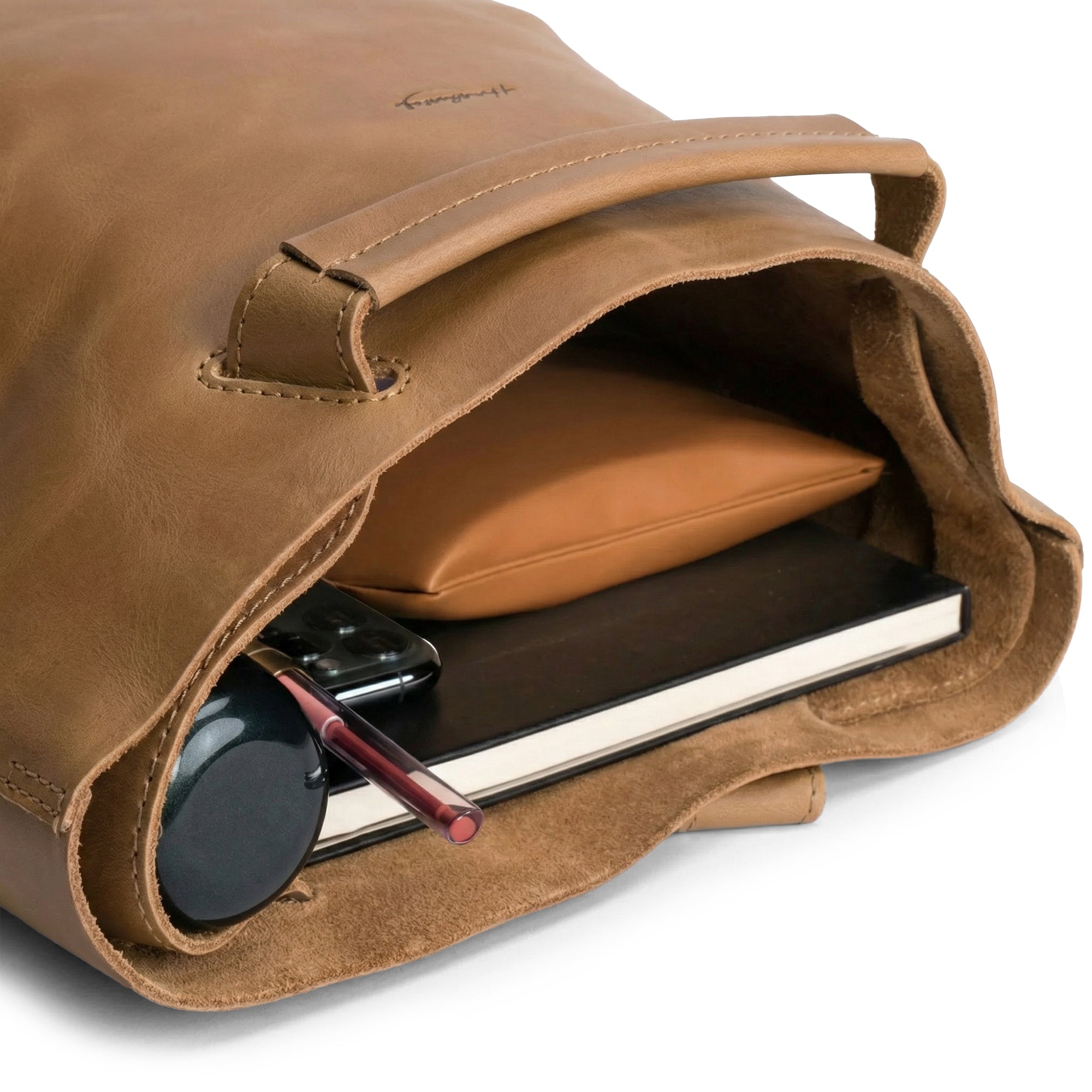 Inside view of Heather's Convertible Backpack to Shoulder Bag, displaying its roomy and functional design. This spacious crossbody for women serves as a squared purse made from Full Grain Leather, reflecting artisan craftsmanship. Handmade in La Antigua Guatemala and Oaxaca Mexico, it features small batch production methods including hand cut and hand sewn details.