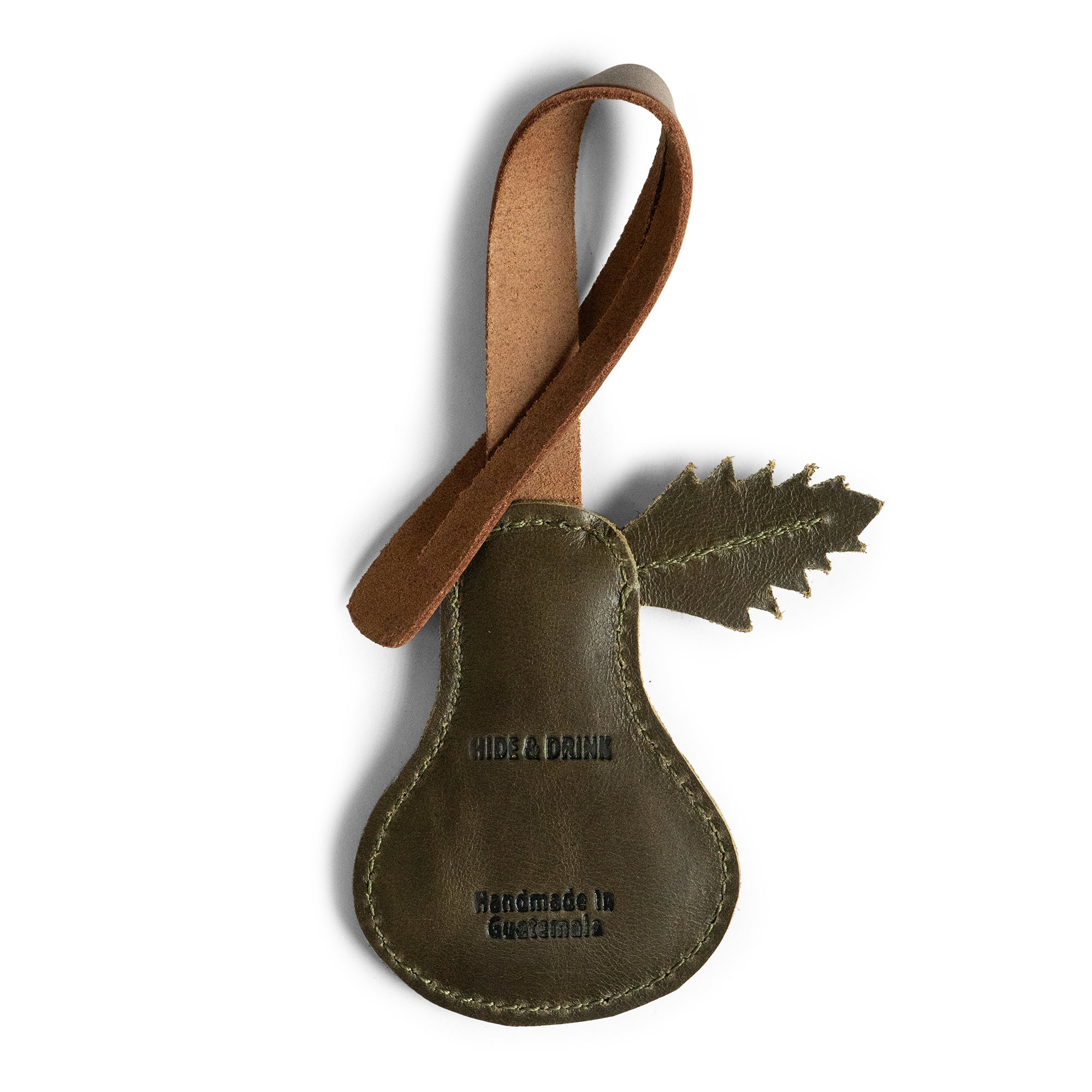 Detailed view of the Pear Bag Charm by Hide & Drink, featuring fire branded logo and leaf accent. This unique accessory is designed for handbags, purses, and backpacks, emphasizing artisan quality with full grain leather, handmade in La Antigua Guatemala & Oaxaca Mexico.