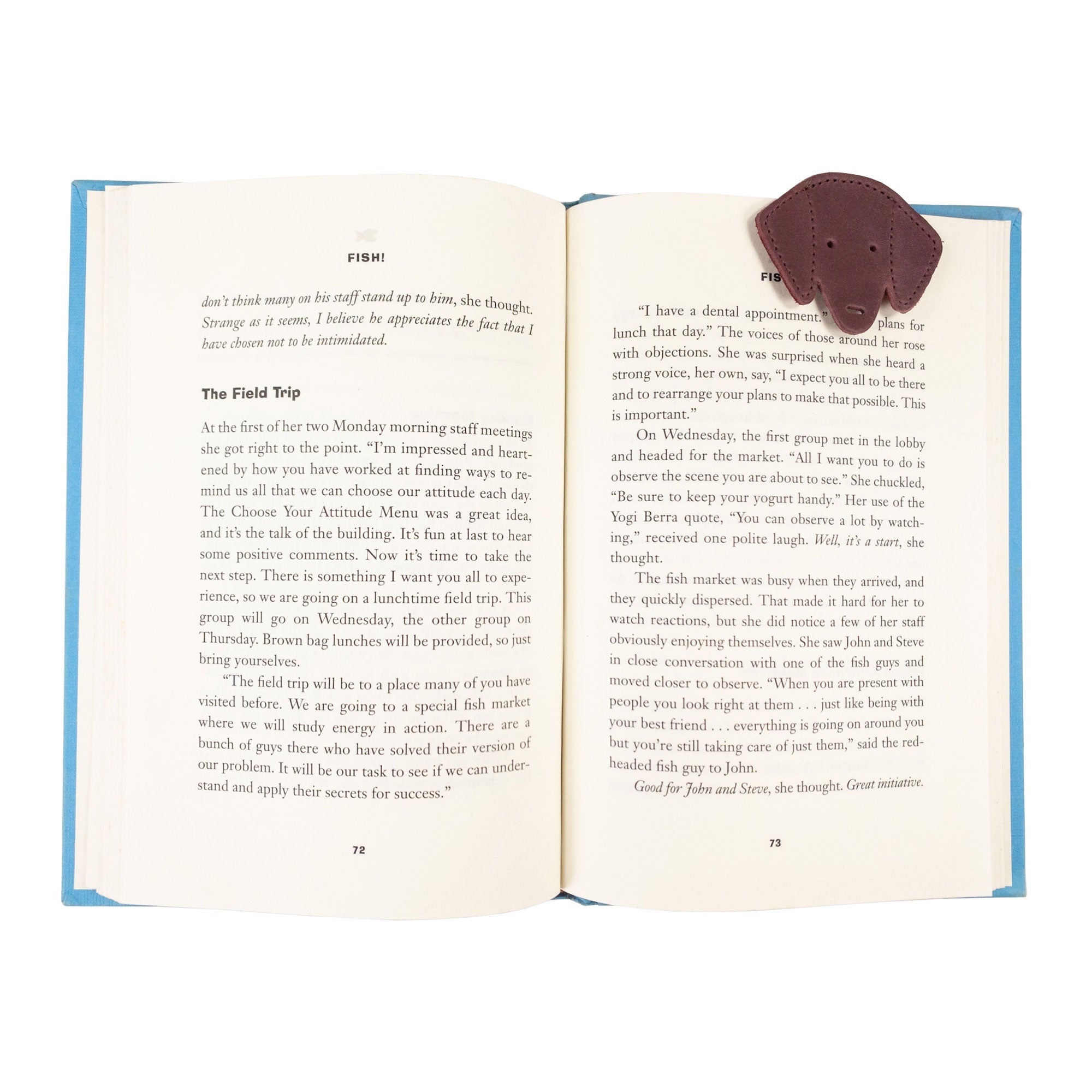 Hide & Drink's burgundy Dog Bookmark in use, adding a stylish touch to any book with its Full Grain Leather material. This handmade bookmark highlights the quality of small batch production and fire branding from La Antigua Guatemala & Oaxaca Mexico.