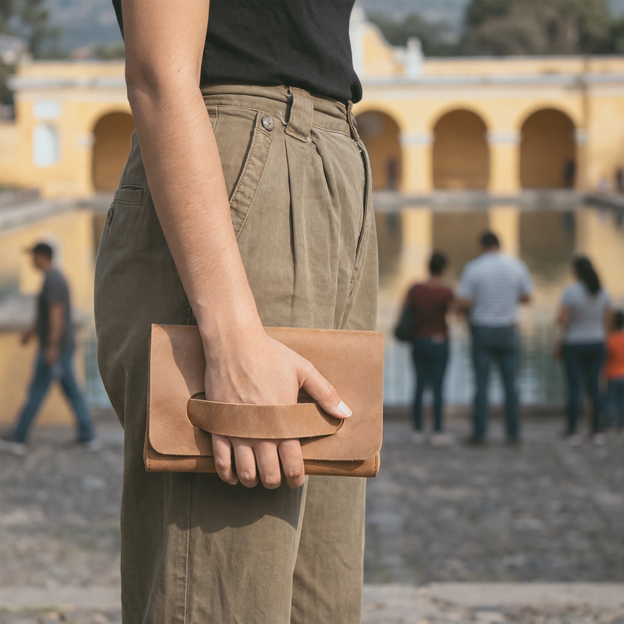 Chic brown Clutch Bag With Handle by Hide & Drink, made from high-quality Full Grain Leather. This handbag for women is perfect as a night bag, showcasing artisan quality through small batch production in Guatemala and Mexico.