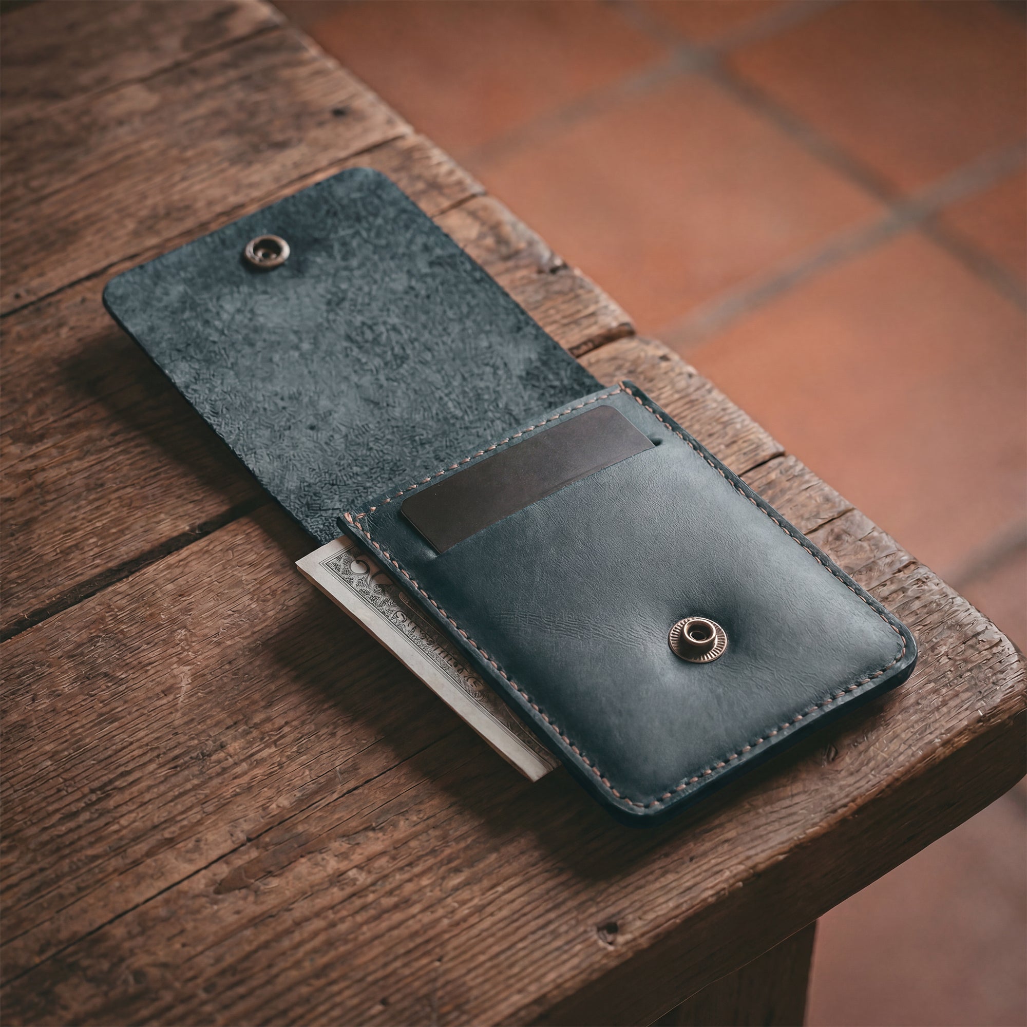 Interior view of the blue Vertical Wallet by Hide & Drink showcasing compartments for cards and notes. This Vertical Front Pocket Wallet with Card Slot provides a stylish solution for compact storage, made from durable full grain leather through small batch production techniques, hand cut and hand sewn with fire branding. Handmade in La Antigua Guatemala & Oaxaca Mexico.