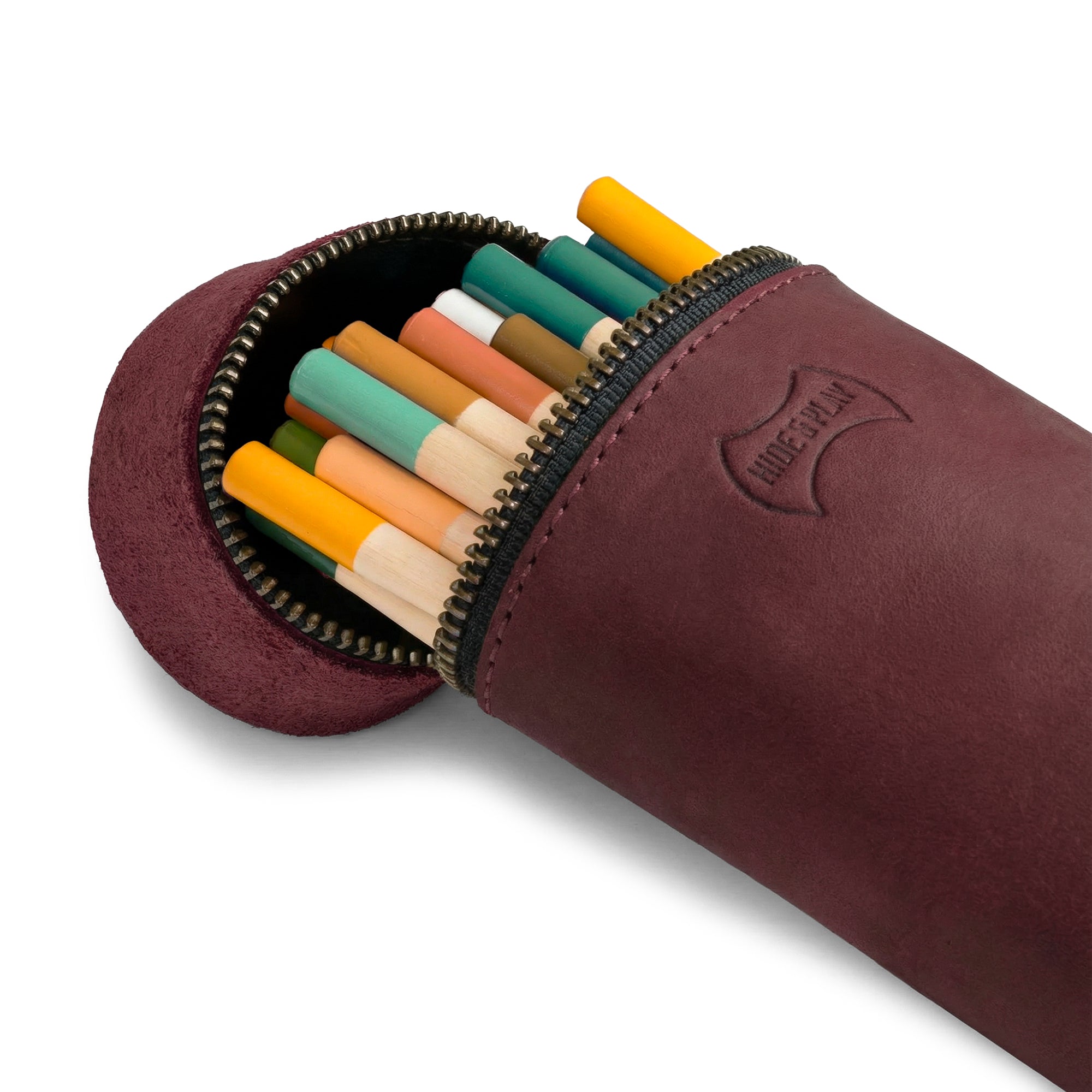 An open Pencil-Shaped Case from Hide & Play filled with colorful pens, illustrating its practical use for organizing writing implements. This zippered bag is made from full grain leather, showcasing artisan craftsmanship through hand cut and hand sewn features, fire branded for authenticity. Handmade in La Antigua Guatemala.