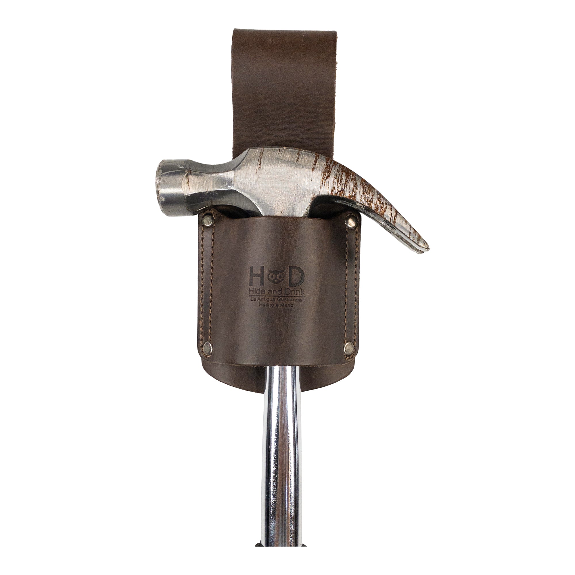 Hammer secured in the Hammer Holster by Hide & Drink, highlighting the tool's accessibility for electricians and construction workers. The rich Full Grain Leather adds a stylish touch while ensuring durability. Hammer Holster - Electrician & Construction, Tool Holder, Organizer, Sheath, Case, Woodwork & Handcraft, Full Grain Leather, StockyardX, Small Batch Production, Hand Cut, Hand Sewn, Fire Branded, Artisan, Handmade in La Antigua Guatemala & Oaxaca Mexico.