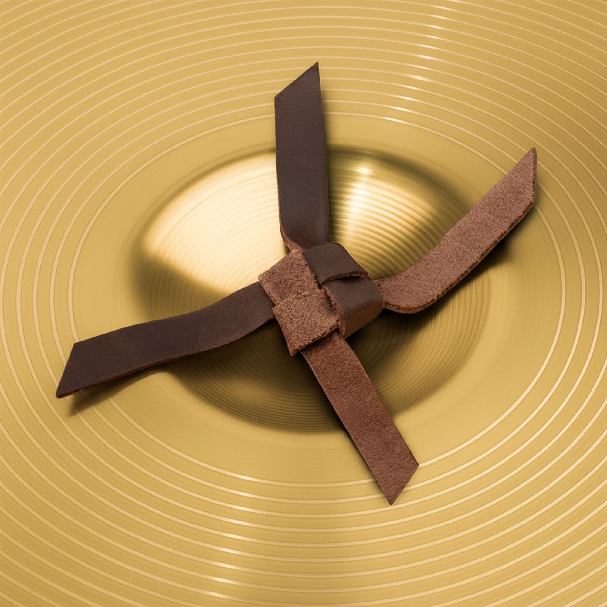 Set of 2 Cymbal Pads by tocame, showcasing two brass cymbals with comfortable leather straps for easy handling. Designed for musicians, these circular cushions enhance sound quality while ensuring comfort. Handmade with love in La Antigua, Guatemala.