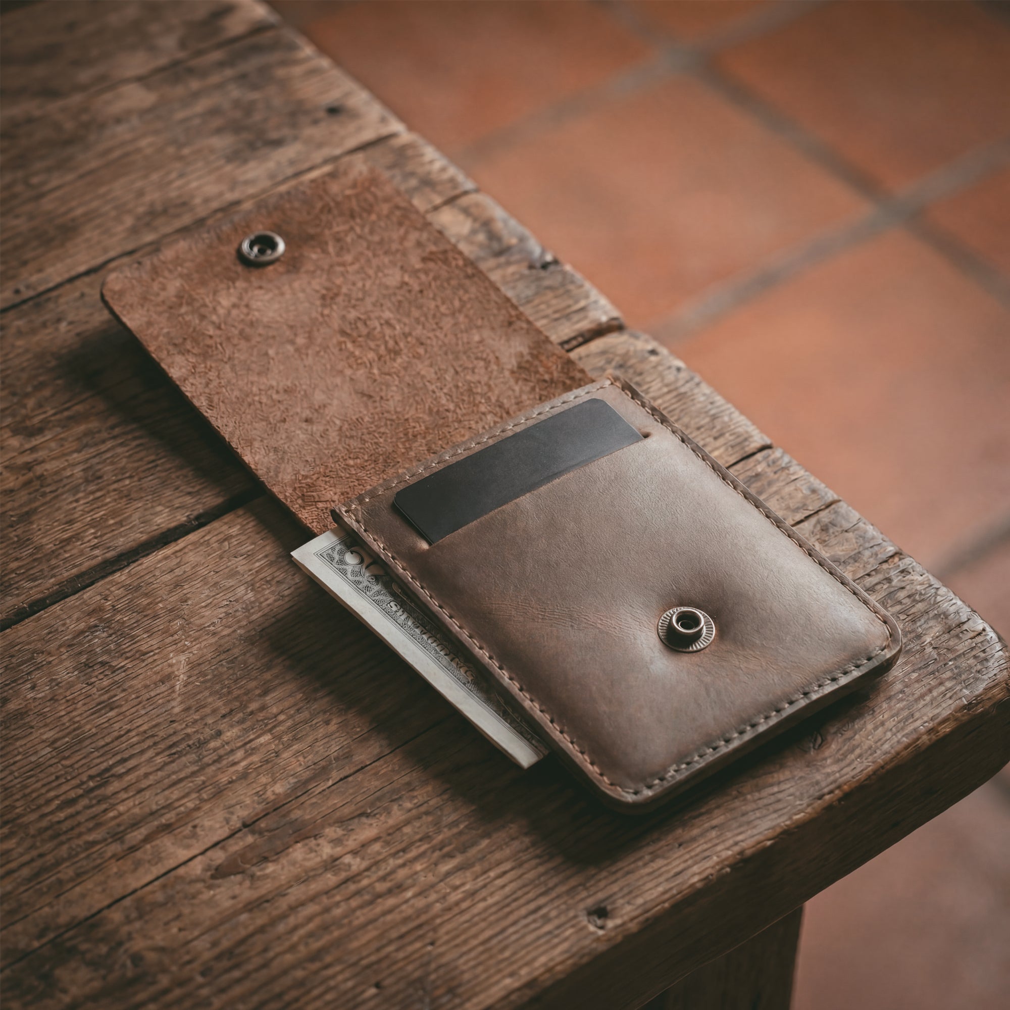 Interior view of the Vertical Wallet by Hide & Drink displaying storage for cards and cash, a perfect compact storage solution. This Vertical Front Pocket Wallet with Card Slot is made of full grain leather, representing small batch production with hand cut and hand sewn finishes, fire branded by artisans. Handmade in La Antigua Guatemala & Oaxaca Mexico.