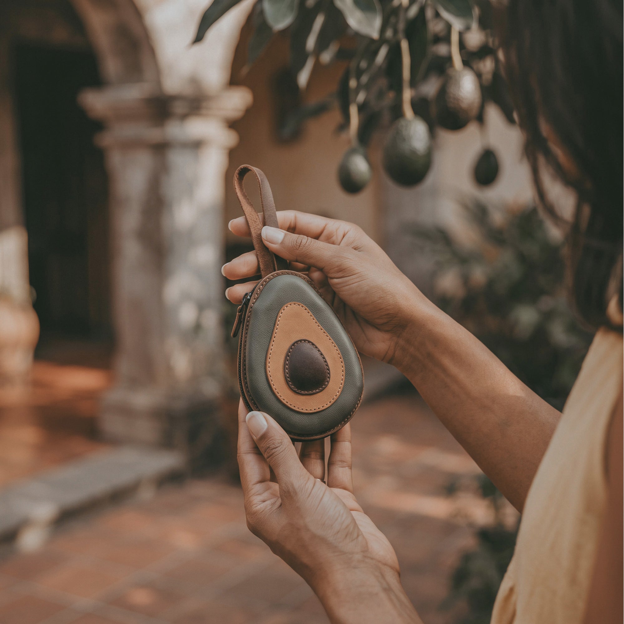 Hide & Drink Avocado Purse, showcasing an attractive front view of this cute case bag that doubles as a card and money organizer. Made from durable full grain leather, this artisan-crafted coin pouch is perfect for thoughtful gifts. Features small batch production with hand cut and hand sewn details, fire branded for authenticity, handmade in La Antigua Guatemala & Oaxaca Mexico.