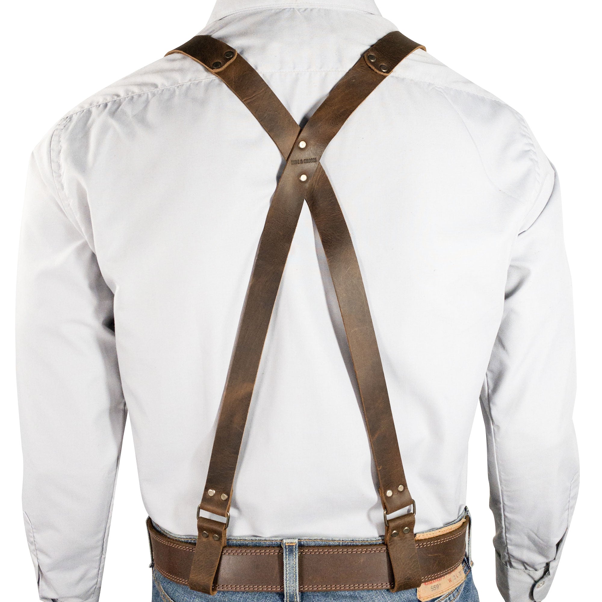 Back view of Riveted X Back Suspenders with Belt Loops by Hide & Groom, demonstrating the elegant cross design and quality craftsmanship. These heavy-duty suspenders are a staple for weddings and steampunk looks, crafted from full grain leather and handmade in La Antigua Guatemala.