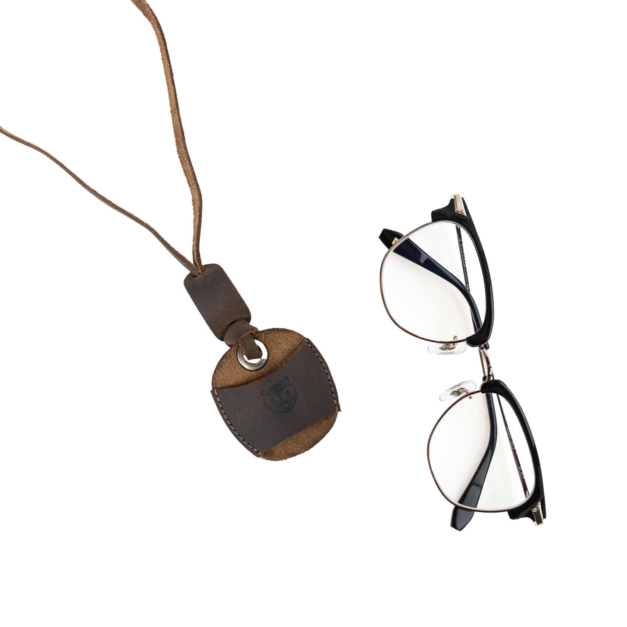 Hide & Drink Eyeglasses Holder with eyeglasses beside it, emphasizing its handy design. This Eyeglasses Holder is made of high-quality full grain leather, ideal for both men and women. Handmade in La Antigua Guatemala & Oaxaca Mexico, showcasing small batch artisan production.