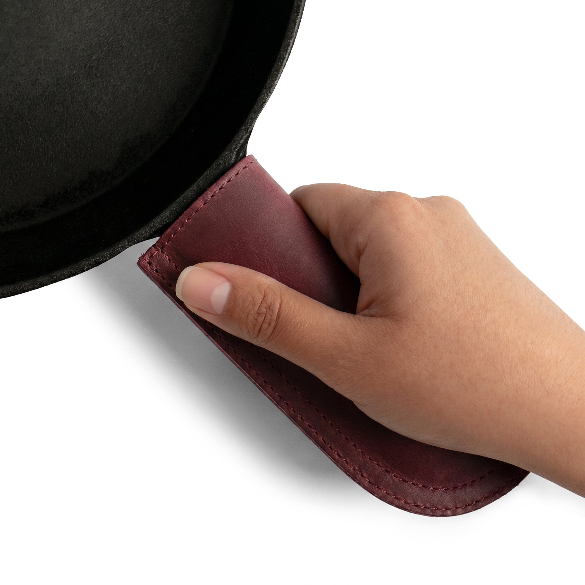 Hide & Drink Cast Iron Panhandle Cover elegantly shown with dimensions. This artisan hot handle protector, made from double stitched full grain leather, combines safety and style. Handmade in La Antigua Guatemala & Oaxaca Mexico, it's a perfect fit for any kitchen.