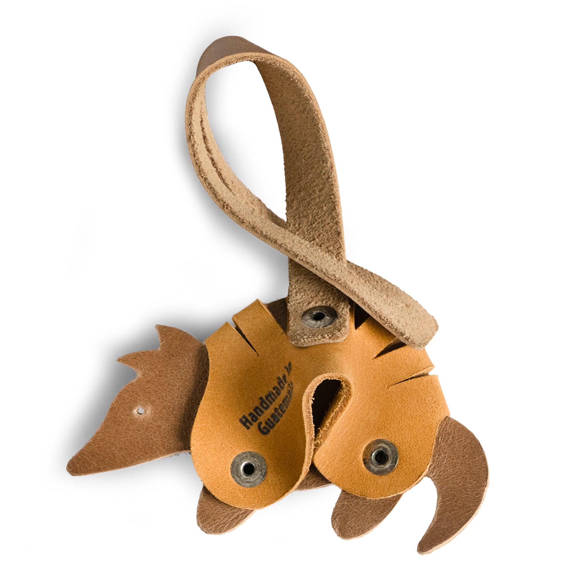 Bag Charms by Austin Genuine shows an armadillo charm with a label 'Handmade in Guatemala.' This Austin Genuine Bag Charm showcases 7 unique designs made with full grain leather from StockyardX, crafted through small batch production, hand cut, hand sewn, and fire branded, artisan, handmade in La Antigua Guatemala & Oaxaca Mexico.
