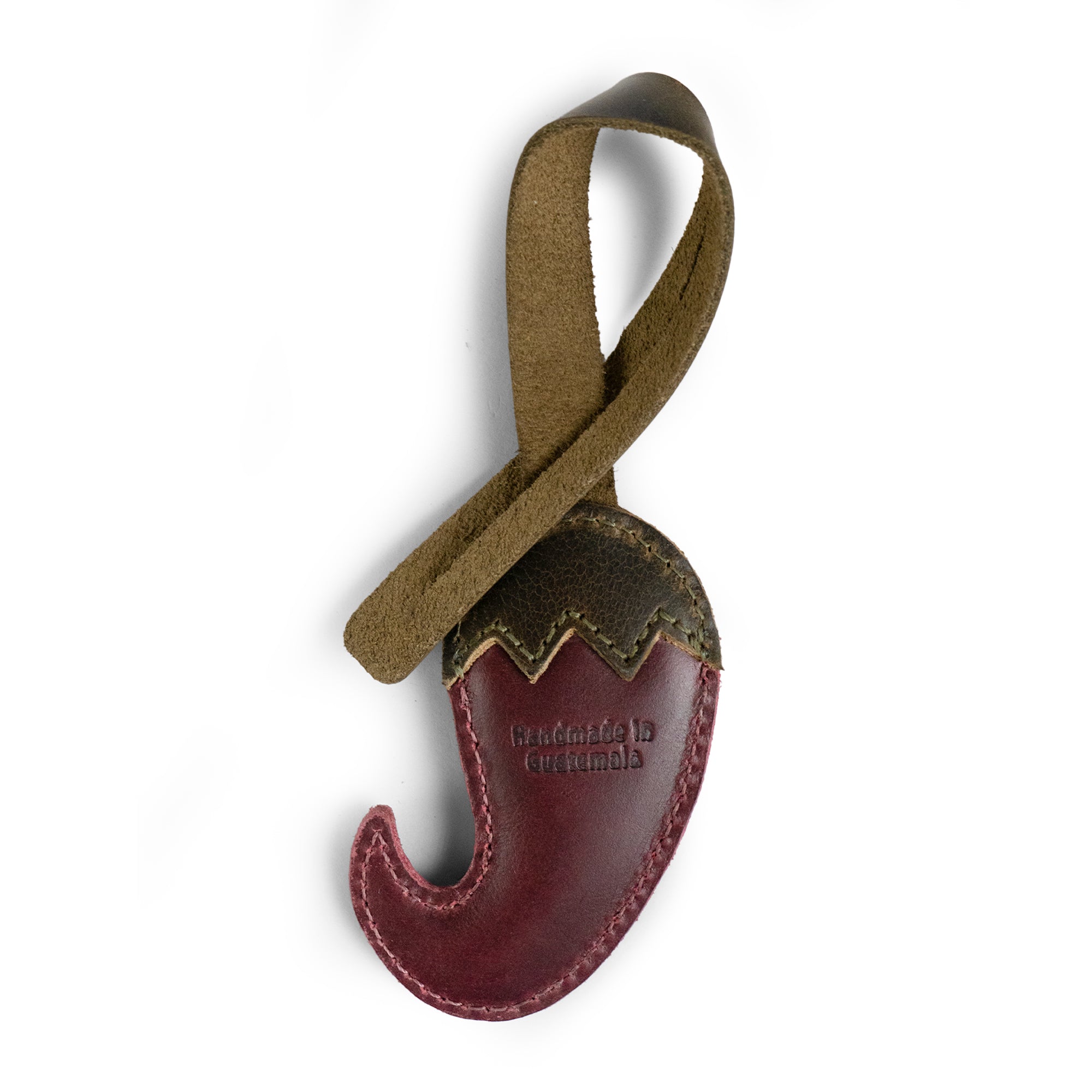 Close-up view of the Hot Pepper Bag Charm by Hide & Drink, featuring artisanal craftsmanship with fire-branded details. This full grain leather charm, handmade in La Antigua Guatemala & Oaxaca Mexico, serves as an excellent ornament for women’s handbags, purses, and backpacks. It reflects quality through small batch production and adds a unique flair to any accessory.