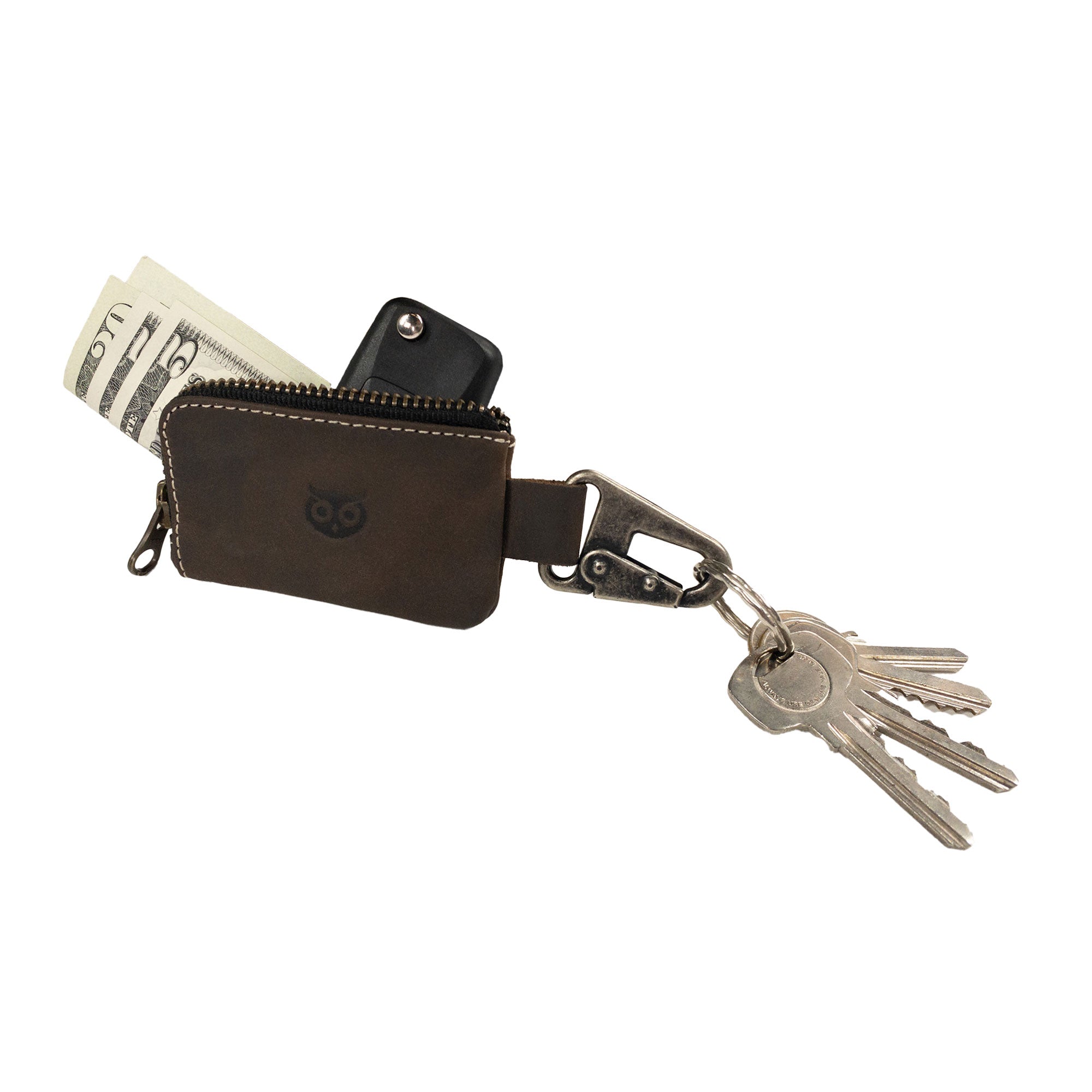 Detailed side view of the Car Key Holder by Hide & Drink, designed for organizing keys and cash, alongside functionalities for Headphone and charging Cables, Memory Cards, and Flash Drives. Constructed from quality Full Grain Leather and featuring a Nickel Metal Clasp, this product reflects artisan craftsmanship from Small Batch Production in La Antigua Guatemala & Oaxaca Mexico.