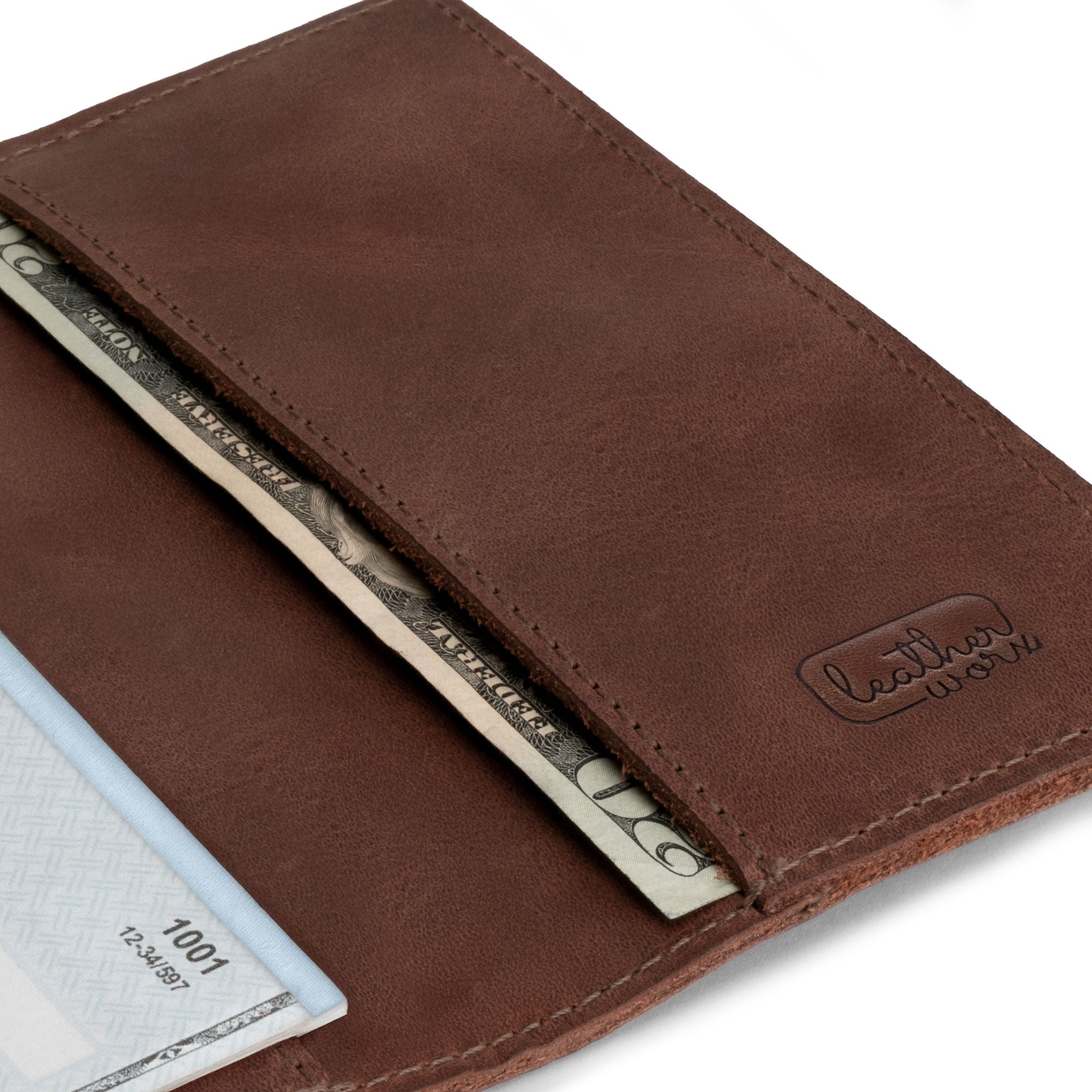 Detail shot of the Leather Worx checkbook cover showing a secured compartment for bills. This full grain leather checkbook cover represents artisan craftsmanship and small batch production, making it an excellent gift for anyone seeking a stylish and functional minimalist organizer for personal or business finances.