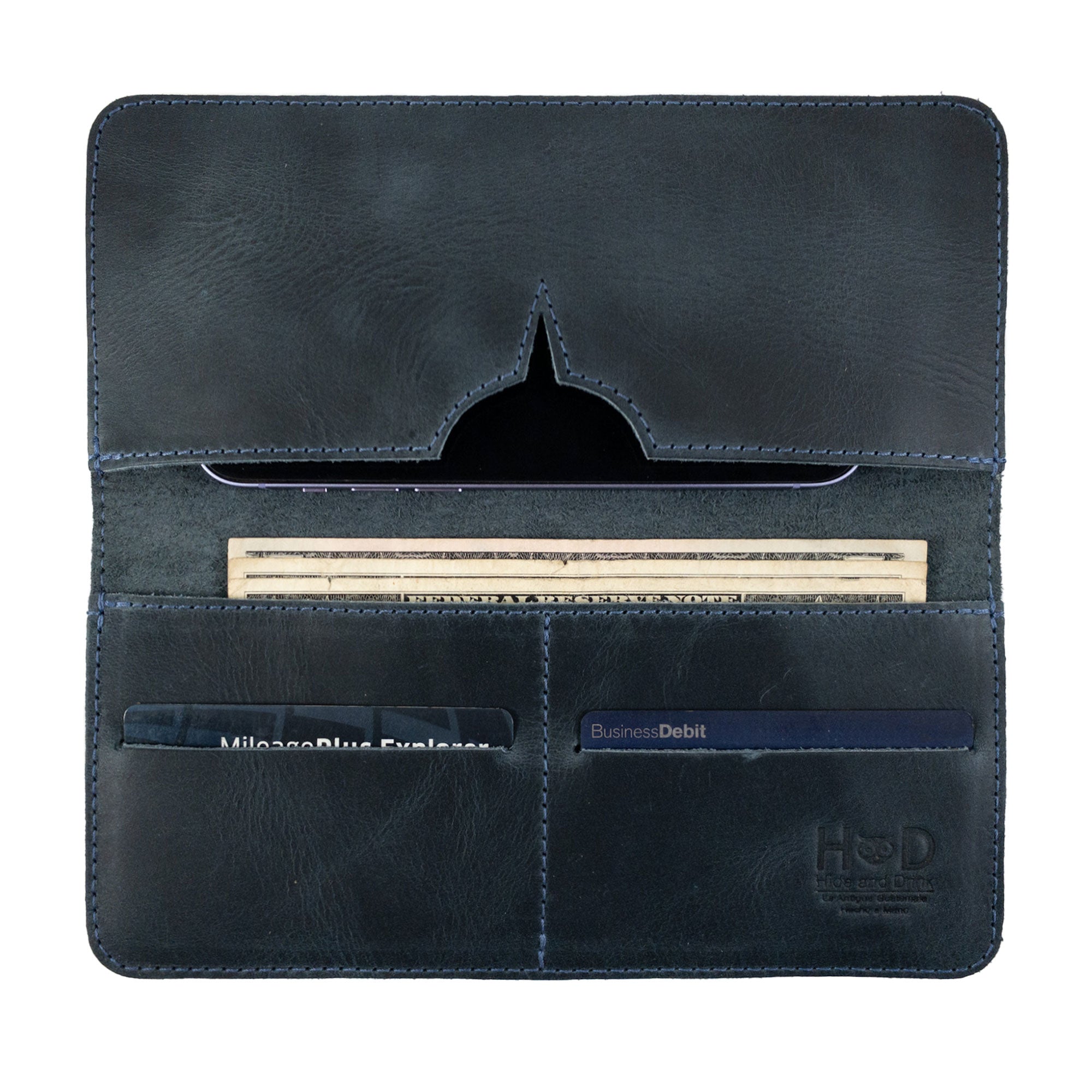 A view of the closed bifold wallet for cellphone by Hide & Drink, showcasing a minimalist design. This sleek Bifold Wallet for Cellphone is made from high-quality Full Grain Leather, reflecting fine artisan skills. Each piece is created through small batch production in La Antigua Guatemala & Oaxaca Mexico.