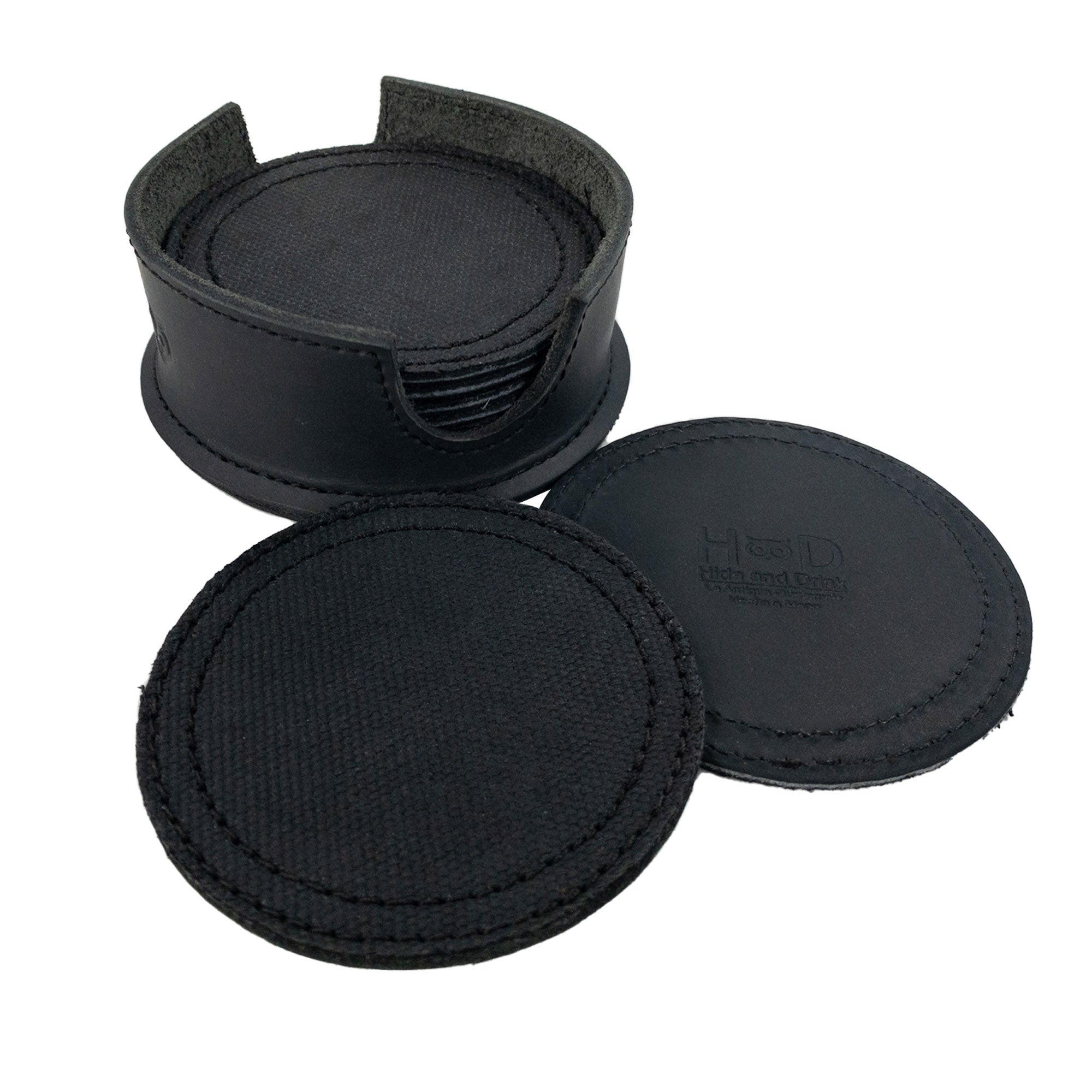 An open leather holder showing multiple coasters from the Set of 8 Circular Coasters for Drinks by Hide & Drink. This set, designed for Glass & Cups Stain Protection, is handmade from rugged Waxed Canvas and Full Grain Leather. Experience the quality of StockyardX with these Small Batch Production coasters that are Hand Cut, Hand Sewn, Fire Branded, and made Artisan, Handmade in La Antigua Guatemala & Oaxaca Mexico.