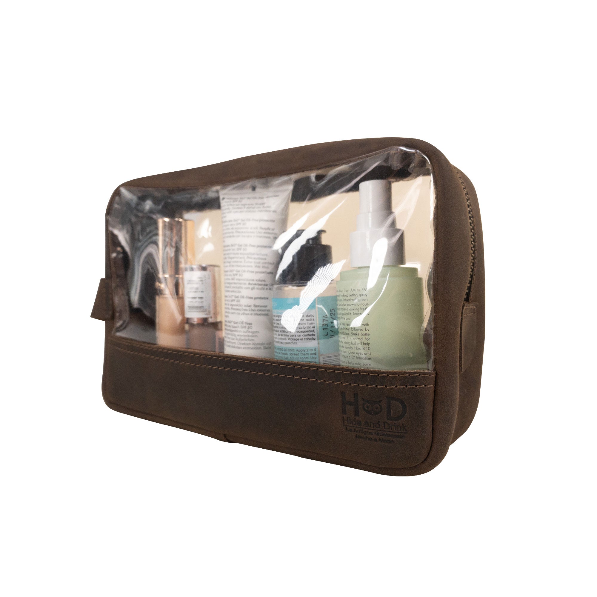 Hide & Drink Transparent Bag for Makeup displaying various beauty products inside, designed for organization and style, made of Full Grain Leather, emphasizing small batch production and artisan craftsmanship from La Antigua Guatemala & Oaxaca Mexico.