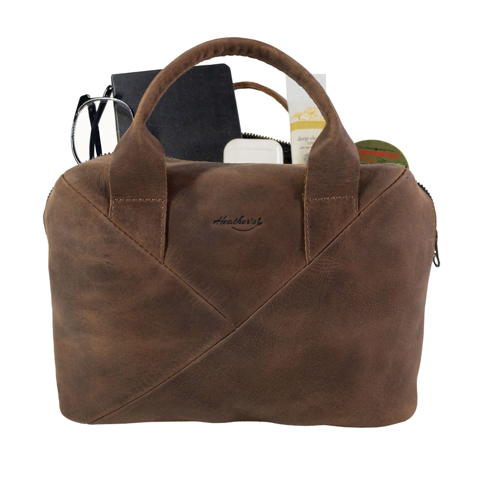 Heather's Fluffy Purse open to display its spacious interior, crafted from Full Grain Leather. This Leather Fluffy Purse makes an excellent Handbag for Women or a stylish Night Bag, along with its usefulness as a Rectangular Purse with Zipper or Travel Make Up Bag. Celebrated for its quality, this bag reflects Small Batch Production, Hand Cut, Hand Sewn details, Fire Branded, and is Handmade in La Antigua Guatemala & Oaxaca Mexico.