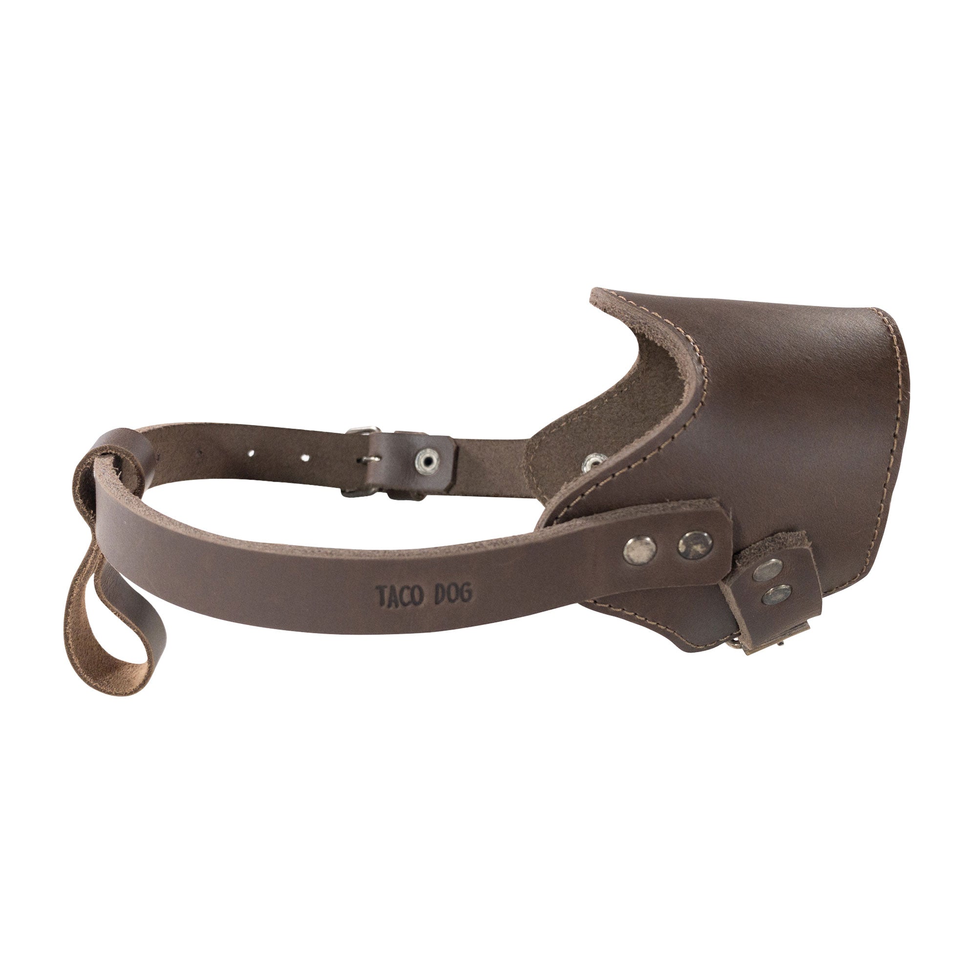 Adjustable Dog Muzzle by Taco Dog from a unique angle, revealing its functional design and artisan quality. This muzzle, made from full grain leather, is perfect for training and outdoor safety, hand crafted in La Antigua Guatemala.