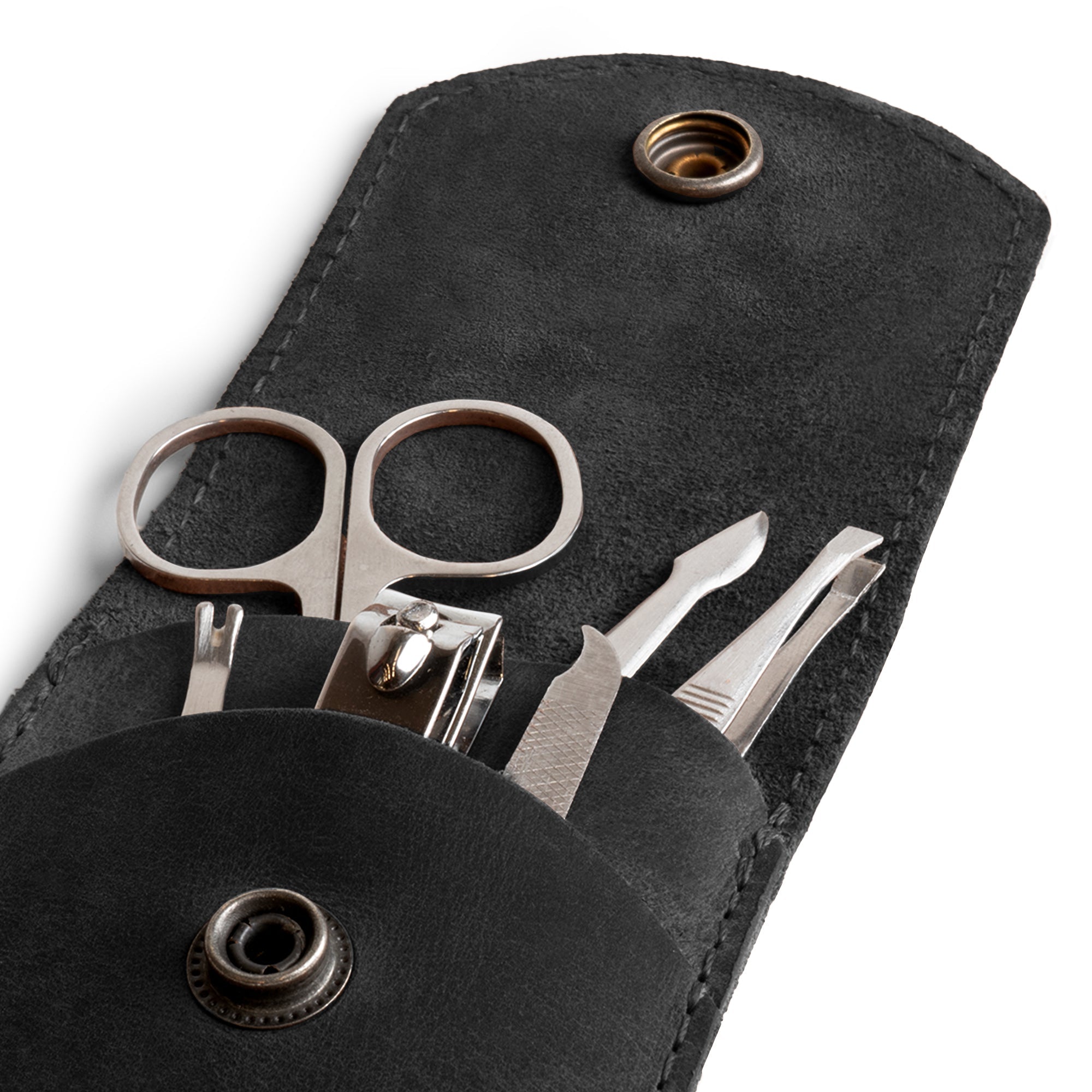 Close-up shot of the black Hide & Drink Nail Clipper Case with tools, highlighting its elegant full grain leather. A luxurious travel accessory, it features artisan craftsmanship with small batch production, hand cut, hand sewn, and fire branded, made in La Antigua Guatemala & Oaxaca Mexico.