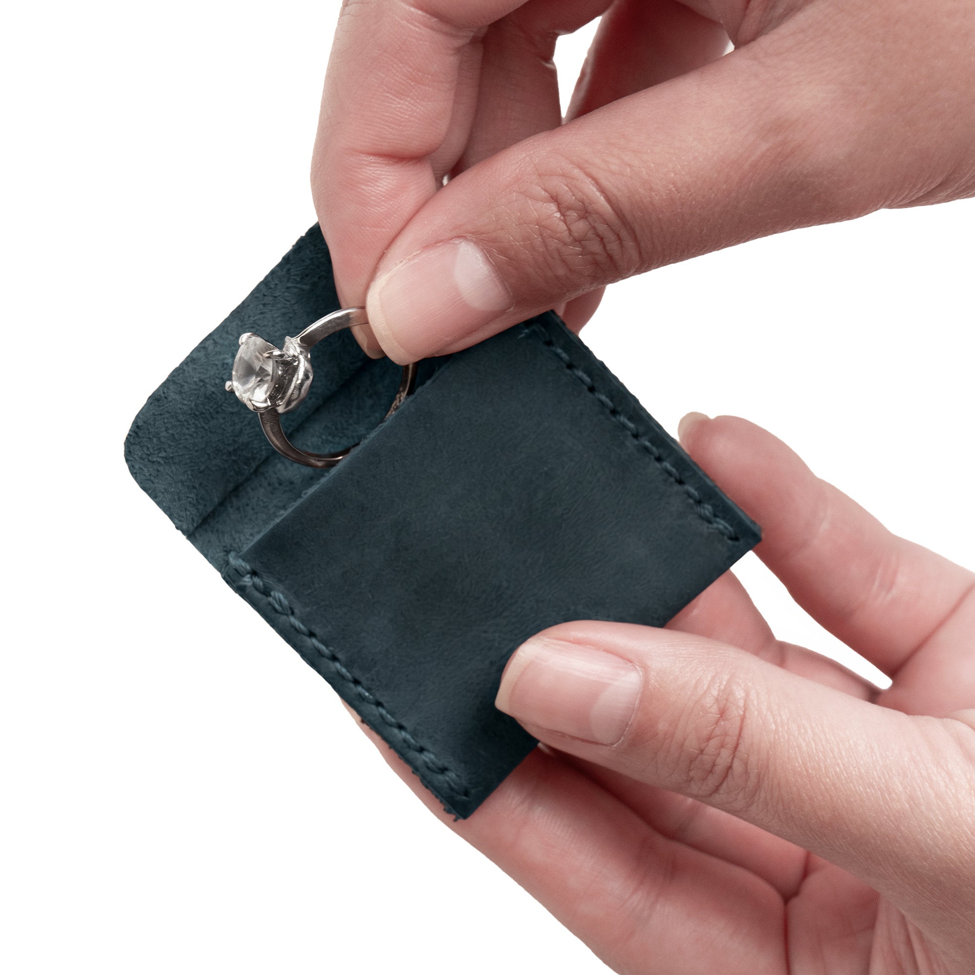 Showcasing Hide & Drink Wedding Ring Case with an engagement ring elegantly positioned. This small bearer and pouch organizer for jewelry is crafted from premium full grain leather, symbolizing handmade quality in La Antigua Guatemala & Oaxaca Mexico.