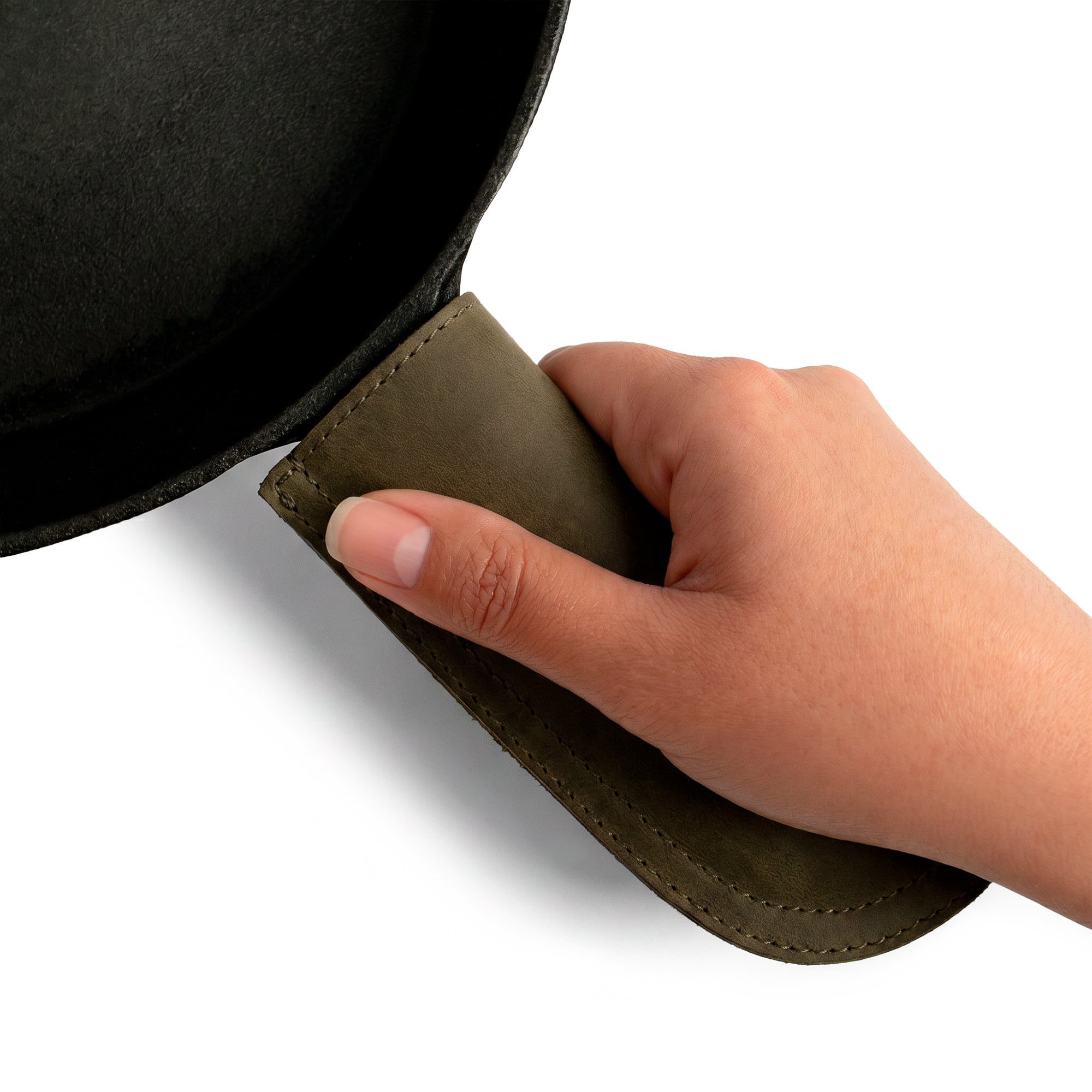 Hide & Drink Cast Iron Panhandle Cover elegantly displayed on a skillet, illustrating its practical features. This artisan hot handle protector is crafted with double stitched full grain leather for durability. Handmade in La Antigua Guatemala & Oaxaca Mexico, it's designed to elevate your cooking experience.