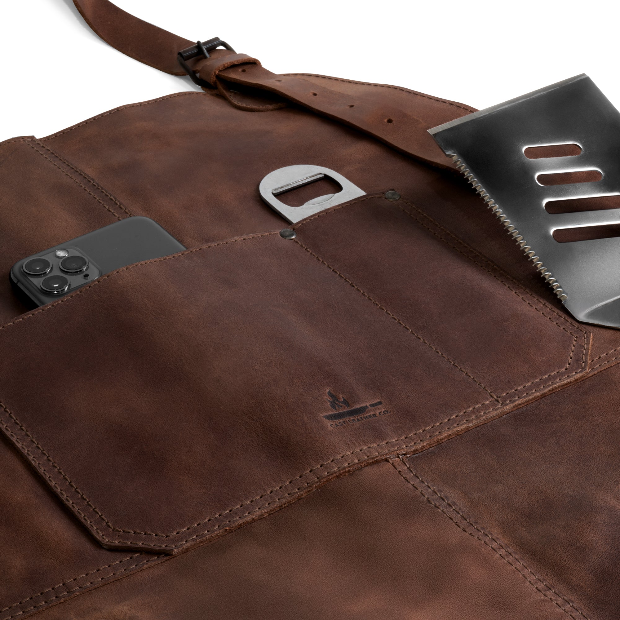 Close-up view of the versatile Grill Apron by Cast Leather Co., featuring pockets for convenience, serving as a Protective Clothing Cover for Cooking and Grilling. This Heat Resistant Full Grain Leather apron combines functionality and style, perfect for your kitchen needs. Artisan quality, Handmade in La Antigua Guatemala & Oaxaca Mexico, highlighting Small Batch Production and Handcrafted methods.