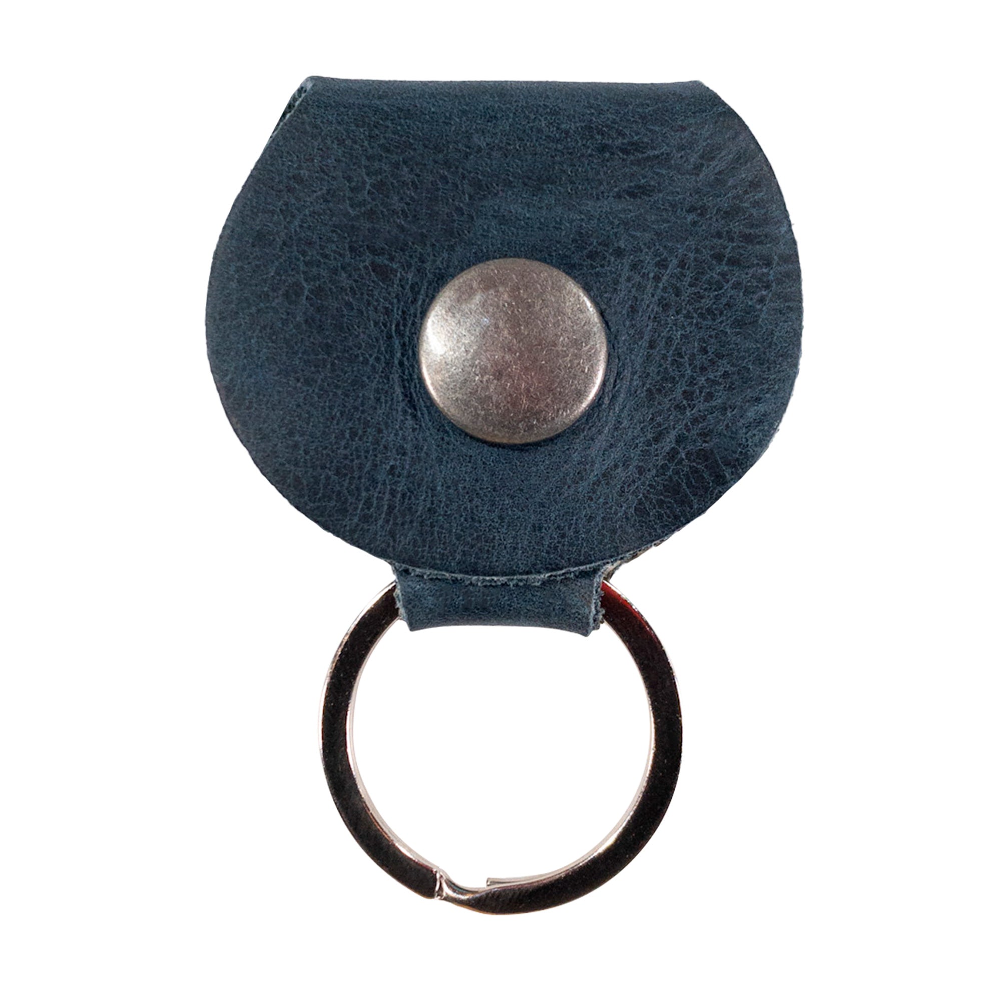 Close up of the button detail on the Key Chain & Guitar Pick Holder by Hide & Drink, showcasing the craftsmanship of the Guitar Pick Holder with Ring. This key organizer for guitar players is made with Full Grain Leather in small batches, focusing on hand cut and hand sewn excellence, artisan quality, and fire branded authenticity, handmade in La Antigua Guatemala & Oaxaca Mexico.