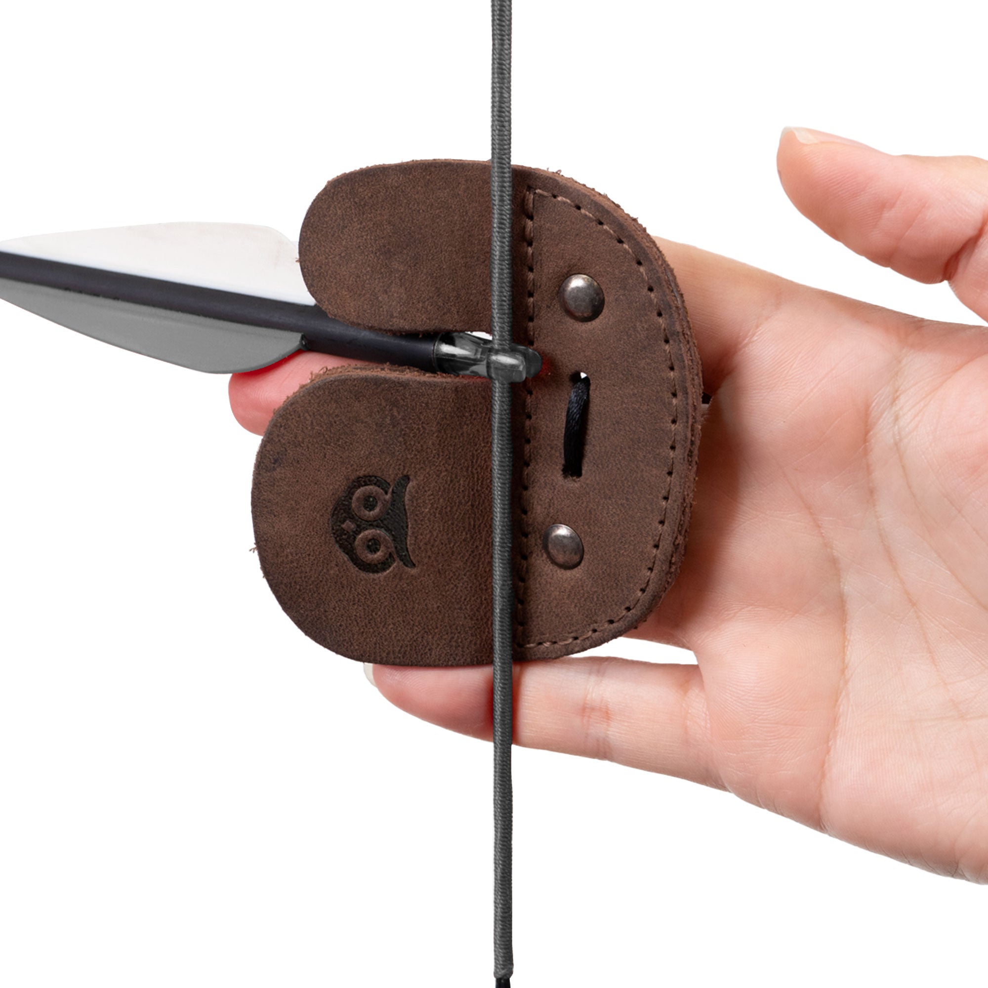 Hand model presenting the Right Handed Archery Finger Protector by Hide & Drink, highlighting its function as an Archery Finger Tab for protecting fingers while shooting. Crafted from Full Grain Leather, this durable Protect Guard is designed for shooting practice gear sports & outdoors enthusiasts. Each piece embodies Small Batch Production with a hand cut and sewn quality, fire branded for an artisan finish in La Antigua Guatemala & Oaxaca Mexico.
