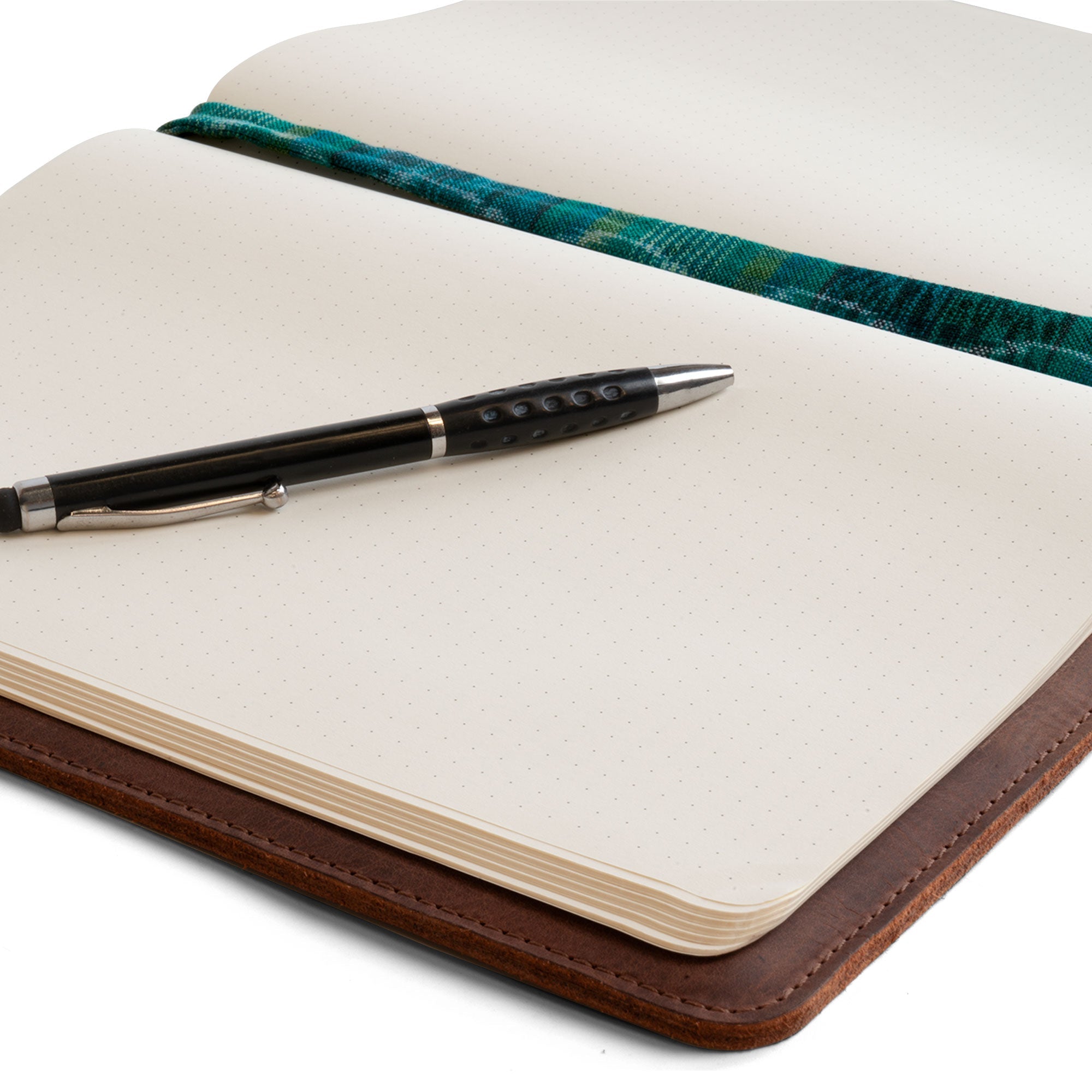 Close-up of the Journal Cover for (8.5 x 11 in.) Moleskine Cahier XXL by Hide & Drink, featuring a sleek design with a pen, emphasizing its elegant texture and durability. This full grain leather journal cover is handcrafted, showcasing artisan skills and small batch production in La Antigua Guatemala & Oaxaca Mexico.
