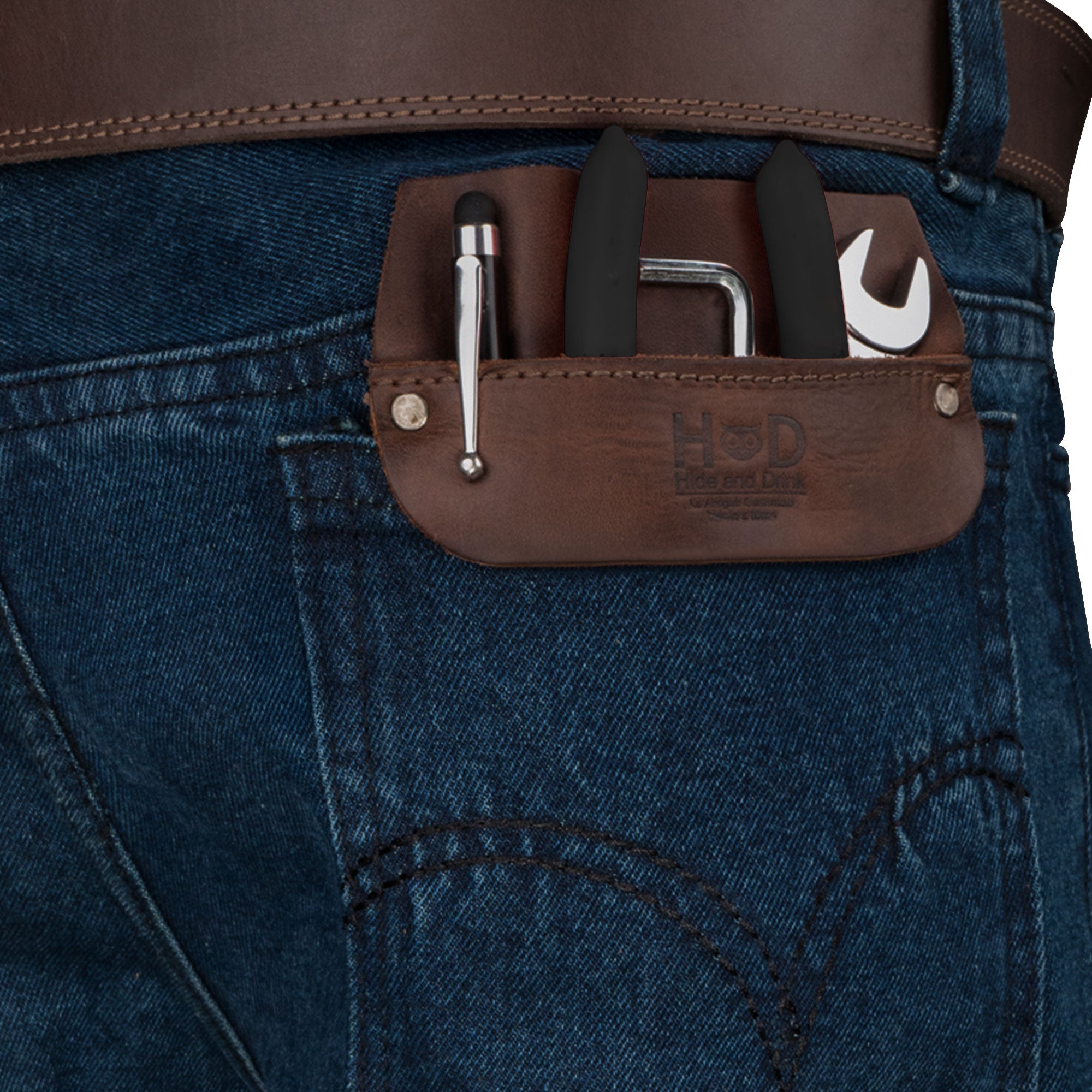 Hide & Drink Leather Work Pocket displayed in a jeans back pocket, illustrating its practical usage for carrying job tools. This versatile Work Pocket Organizer for Tools boasts artisan quality with Fire Branded workmanship from La Antigua Guatemala.