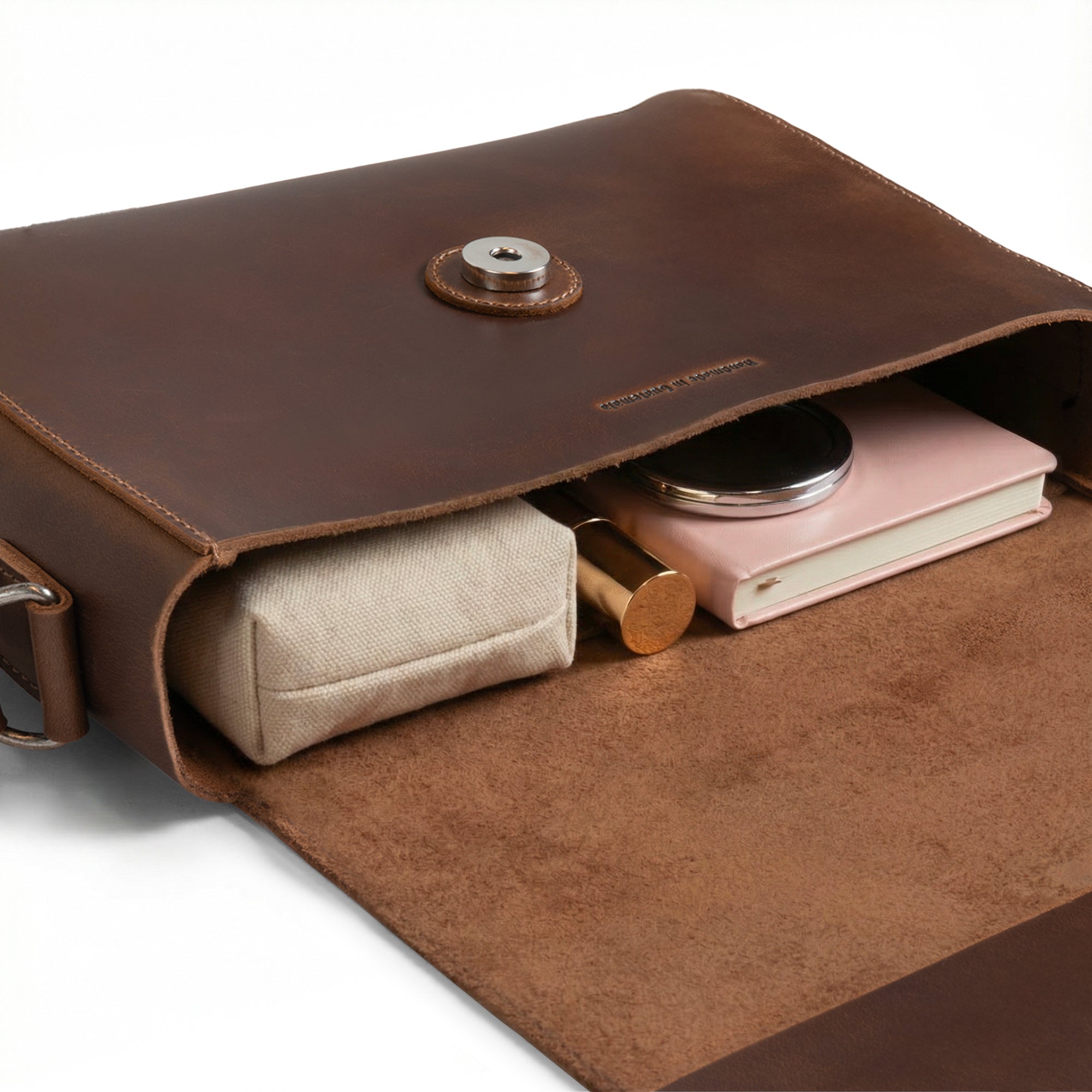 Inside The Barton Purse by Austin Genuine, discover thoughtful storage with a cozy section for essentials like cosmetics and notebooks, reflecting the luxury of full grain leather. This exquisite piece is inspired by Austin’s bold passion, vibrant culture, and embodying the Texas spirit through artisan handmade craftsmanship.