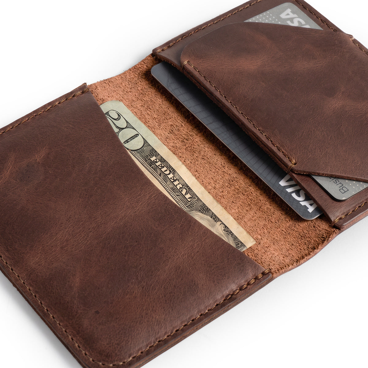 Bi-Fold Card Wallet Diagonal by Hide & Drink opened up to show cards and cash, designed for organization with a sleek aesthetic, made from artisan-quality full grain leather, perfect for everyday accessories.