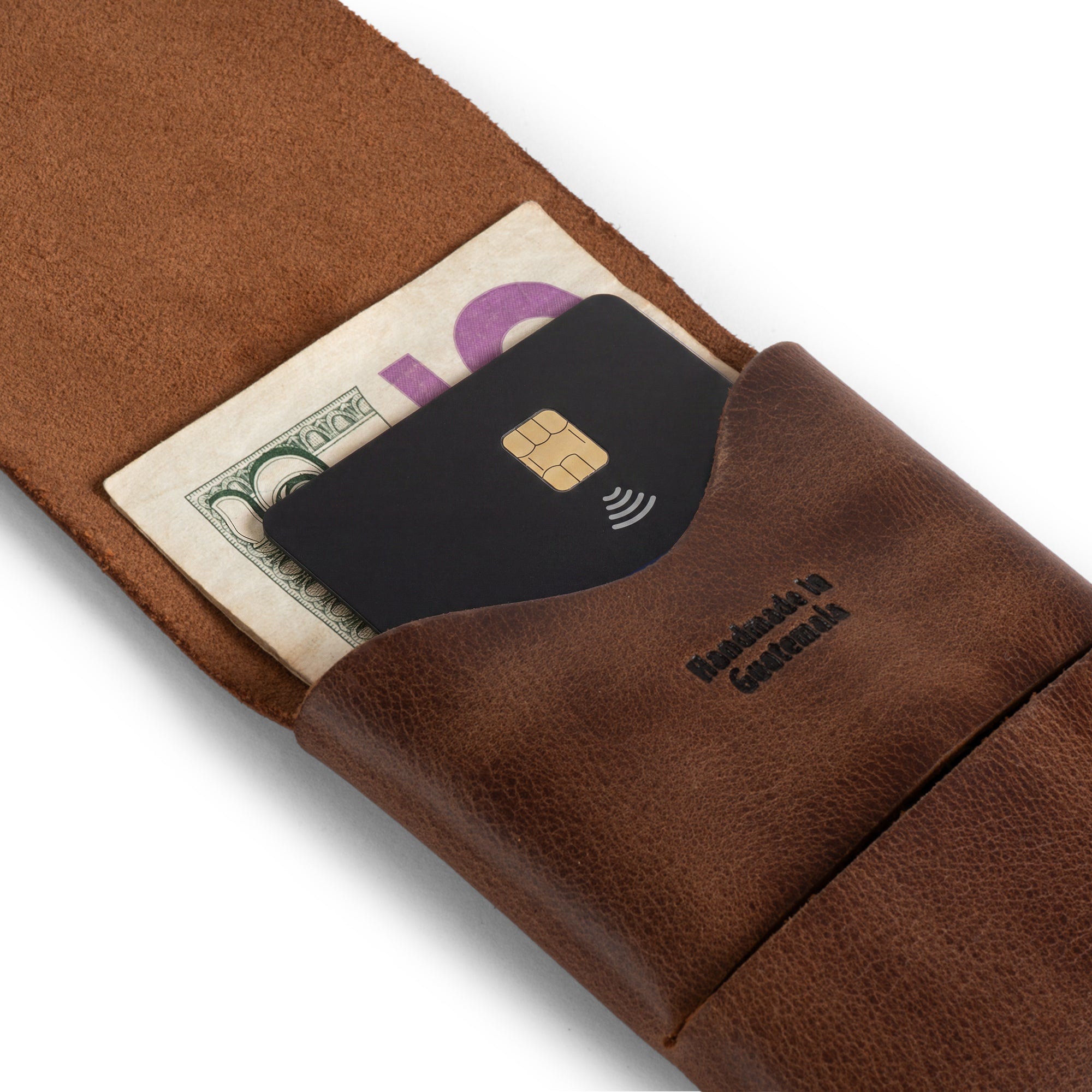 The Origami Card Wallet from Hide & Drink featuring a card and cash holder design, emphasizing its elegant functionality. This Leather Origami Card Holder acts as a Slim Wallet for Cards and Front Pocket Case for Debit & Credit Cards. With a focus on artisan craftsmanship, this compact business wallet is handmade in La Antigua Guatemala & Oaxaca Mexico.