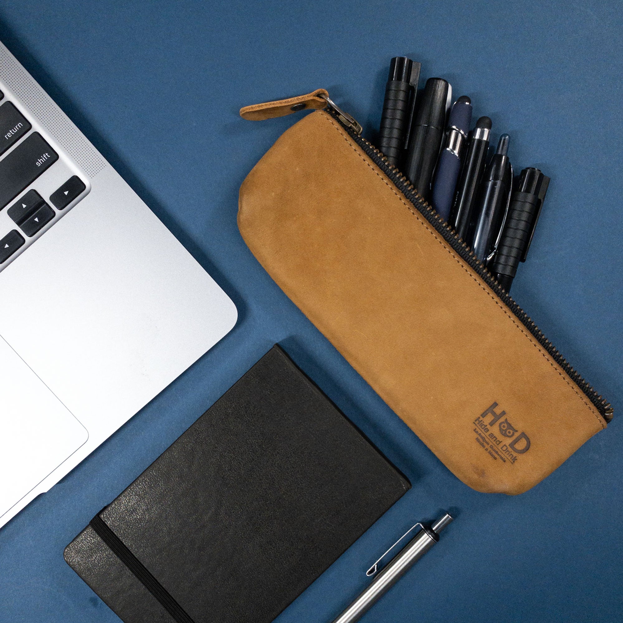 Pencil Pouch by Hide & Drink in an open position revealing its interior. This rectangular pencil case, made from full grain leather, serves as a zippered pen and marker pouch ideal for men and women. Hand sewn in La Antigua Guatemala, showcasing classic artist style.