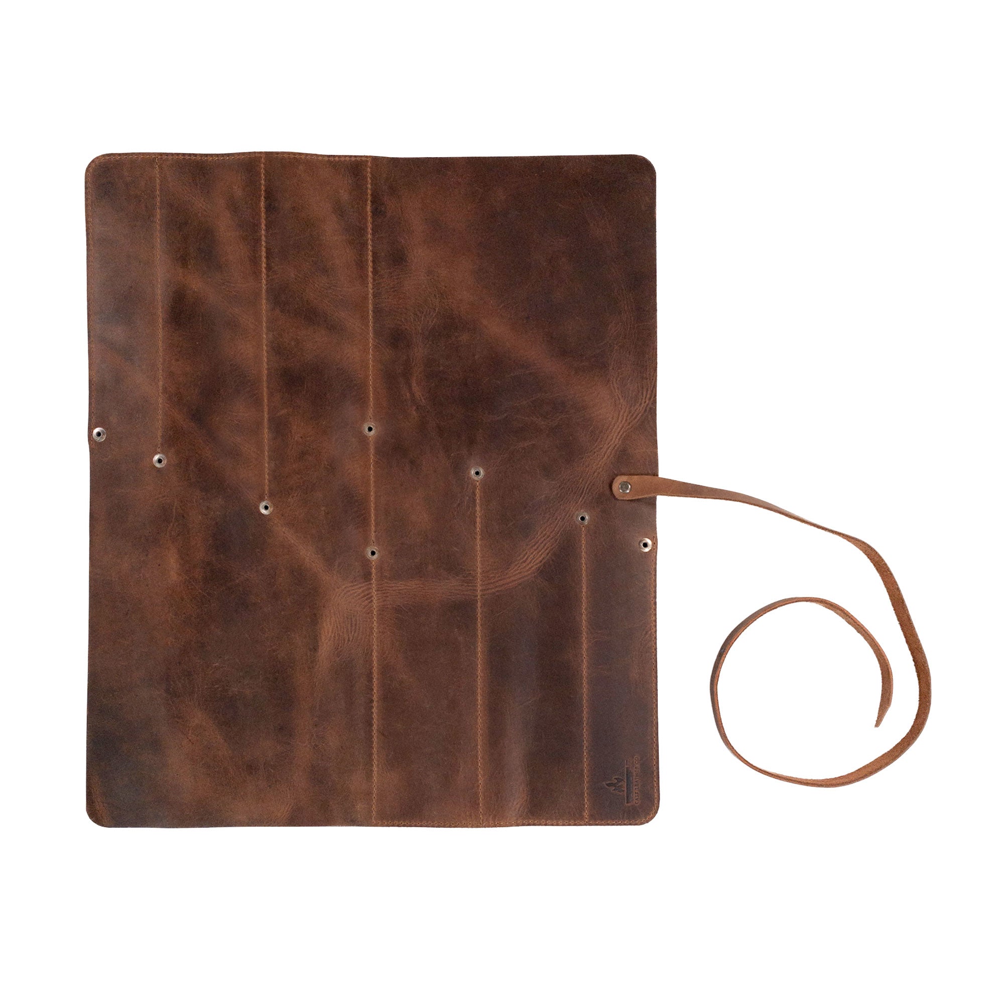 An open Cast Leather Co. Rectangular Knife Case with 6 Slots showcasing its spacious slots for knives. This Portable Knife Organizer Case is crafted for culinary enthusiasts. Made from durable Full Grain Leather, it serves as a perfect cooking accessory. StockyardX highlights its commitment to small batch production, featuring hand cut, hand sewn quality, and a fire branded design, all handmade in La Antigua Guatemala & Oaxaca Mexico.