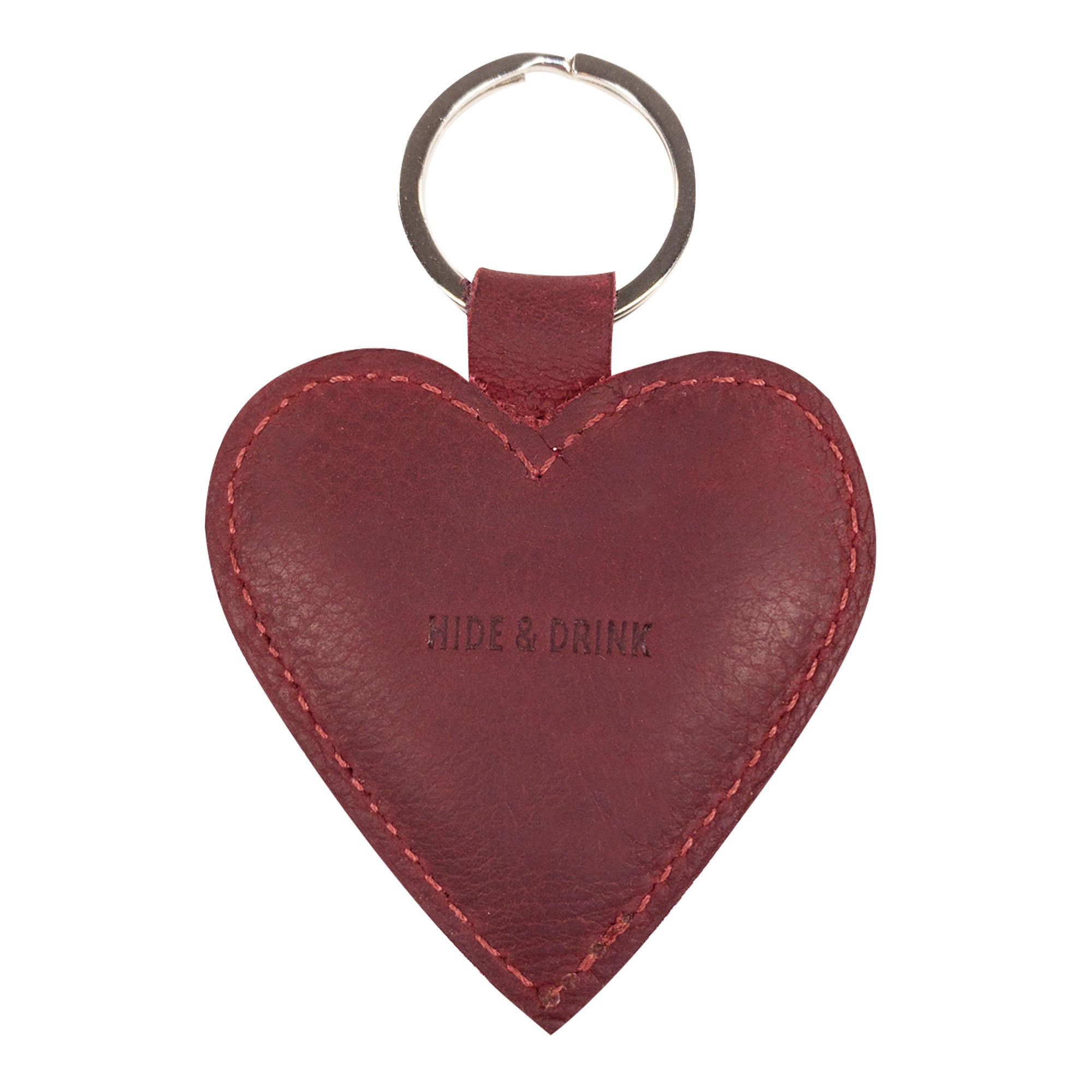 The back view of the Heart Keychain by Hide & Drink, featuring the brand name elegantly embossed on the leather. This lovely heart-shape keychain is perfect for anyone looking for a charming key organizer. Hand cut and hand sewn, this artisan piece is produced in La Antigua Guatemala & Oaxaca Mexico, highlighting its uniqueness.