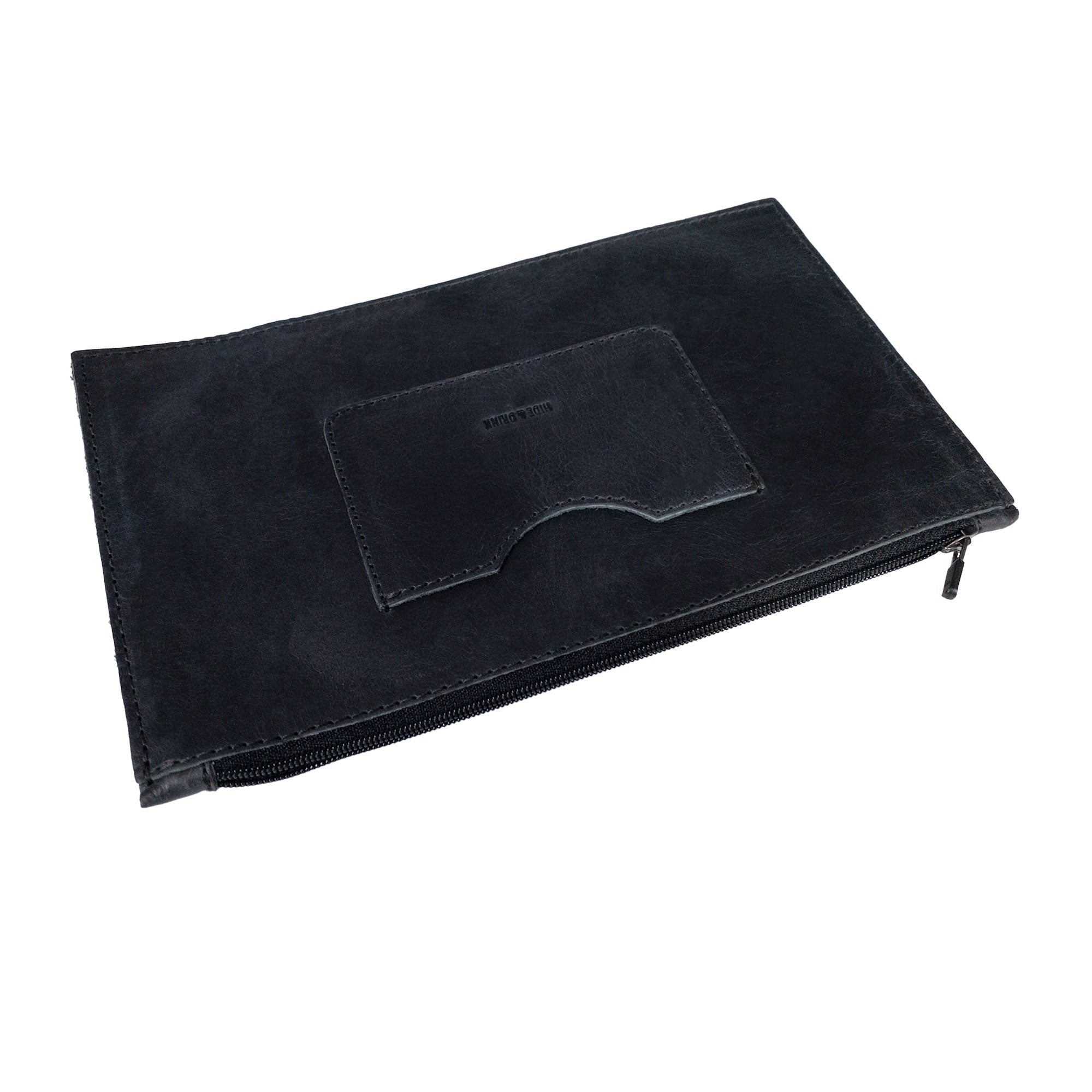 A side perspective of a black rectangular zippered handbag by Hide & Drink, revealing its elegant silhouette. Perfect for women, this full grain leather female purse incorporates a card slot and embodies artisan skill through small batch production, hand cut and hand sewn, made in La Antigua Guatemala & Oaxaca Mexico.