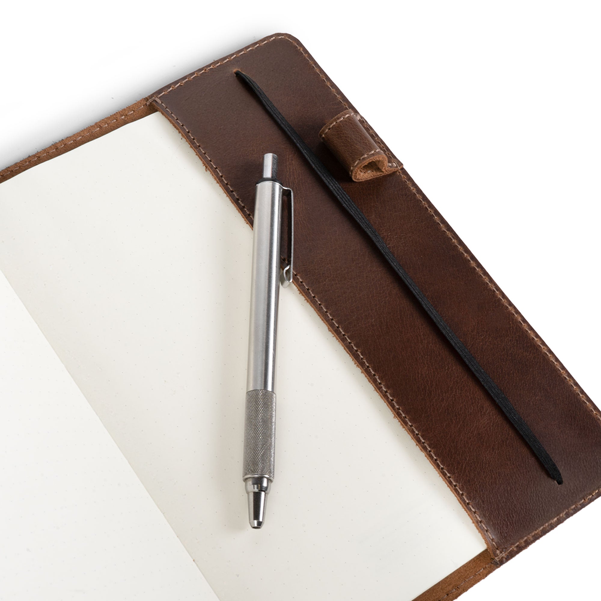 Close-up of the Cover for Leuchtturm1917 Notebook 411 Hardcover A5 Size (145 x 210 mm) by Hide & Drink, featuring the notebook sleeve with a pen holder. This artisan creation, made from full grain leather, offers a stylish way to keep your notes organized while reflecting unique quality from hand cut and hand sewn processes.