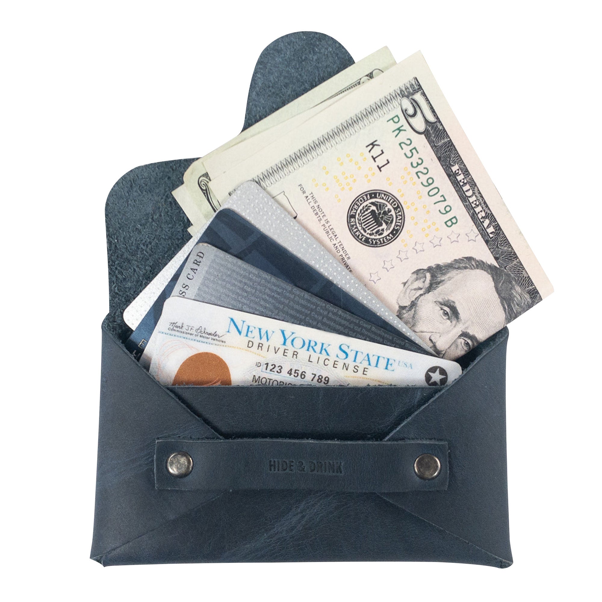 A Snapless Business Card Holder by Hide & Drink, artfully filled with bills and cards, highlighting its practical features. This vintage wallet, ideal for men and women, is made from durable Full Grain Leather, acting as a sturdy pouch and money organizer, hand cut and crafted in La Antigua Guatemala and Oaxaca Mexico.