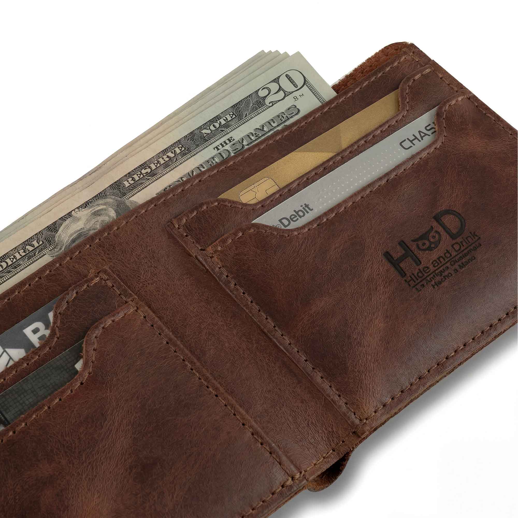 Close-up of the pocket of the Classic Wallet by Hide & Drink, with cash peeking out. This Classic Bifold Wallet is expertly crafted from Full Grain Leather, providing a durable storage case for identification. Known for its quality, it serves as a travel accessory and showcases artisan craftsmanship through small batch production, hand cut and sewn in La Antigua Guatemala & Oaxaca Mexico.