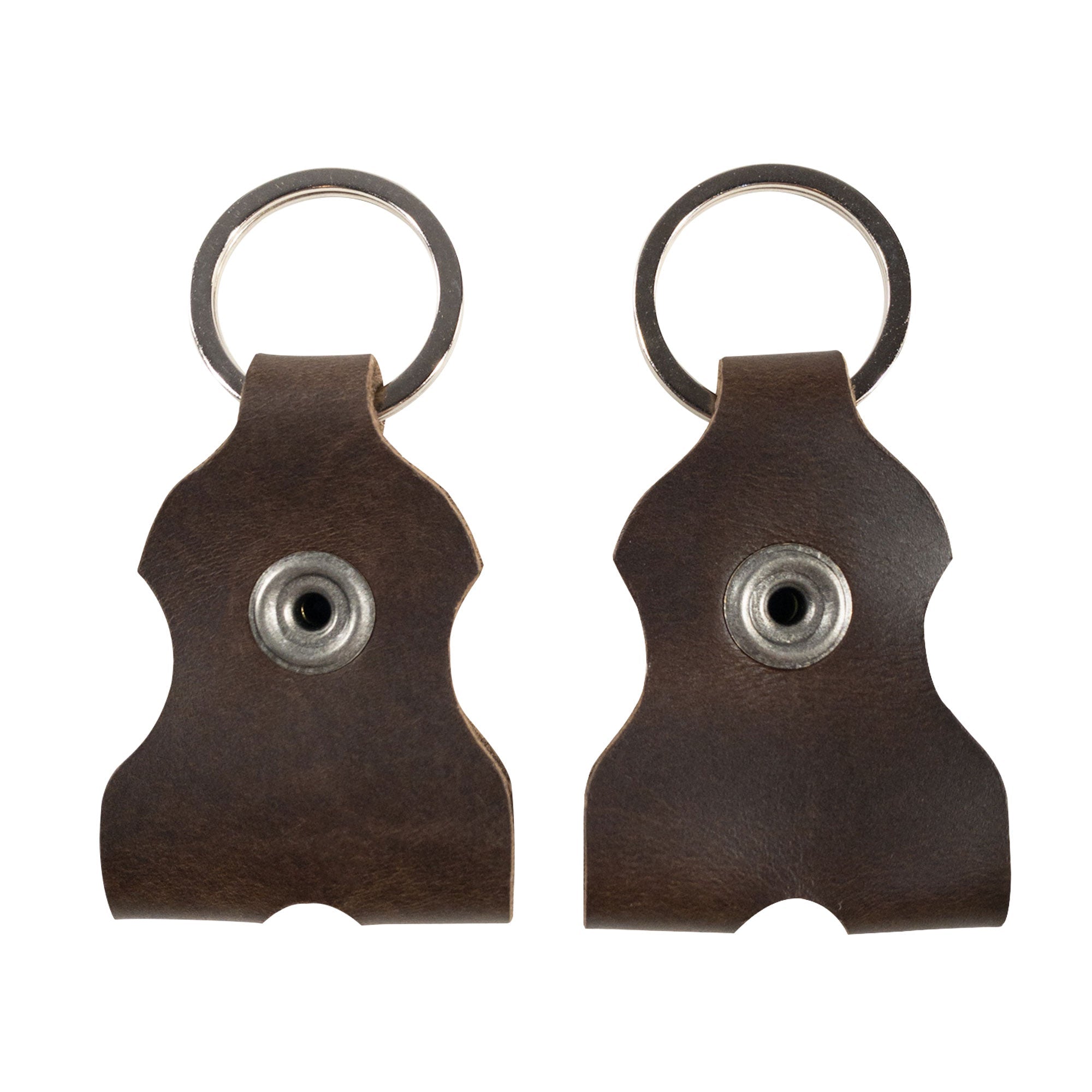 Close-up view of two keychains by tocame, part of the Set of 2 Keychains for Drum Tunners (Not Included). These classic key organizers are made of full grain leather and designed to keep your drum tuning tools secure. Each piece is handcrafted, showcasing the quality associated with small batch production and the artisan touch from La Antigua Guatemala & Oaxaca Mexico.