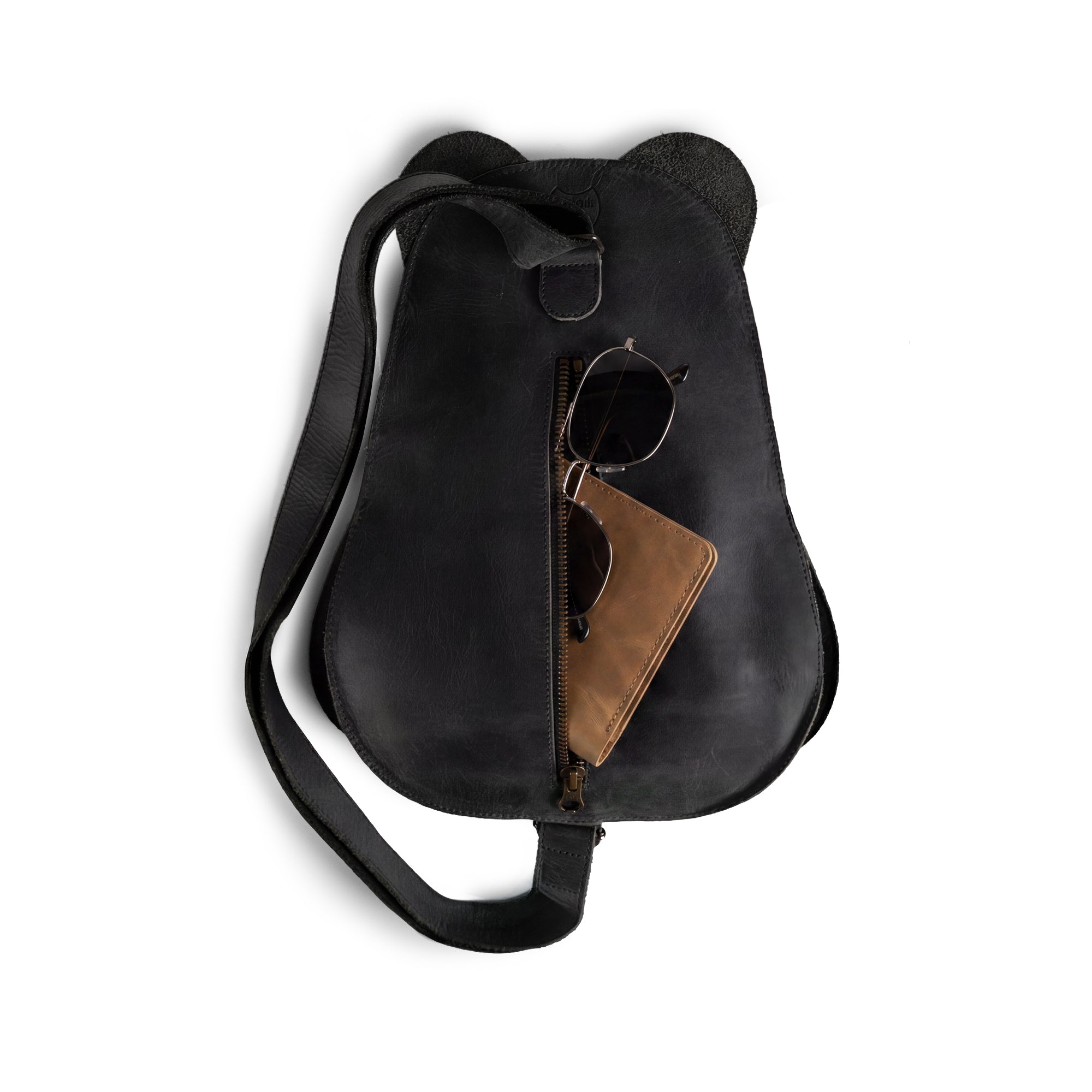 Side profile of the Panda-Shaped Crossbody Bag by Hide & Play, demonstrating its unique panda shape and adjustable strap. A perfect blend of style and function, made with fire branded full grain leather in small batch production from La Antigua Guatemala & Oaxaca Mexico.