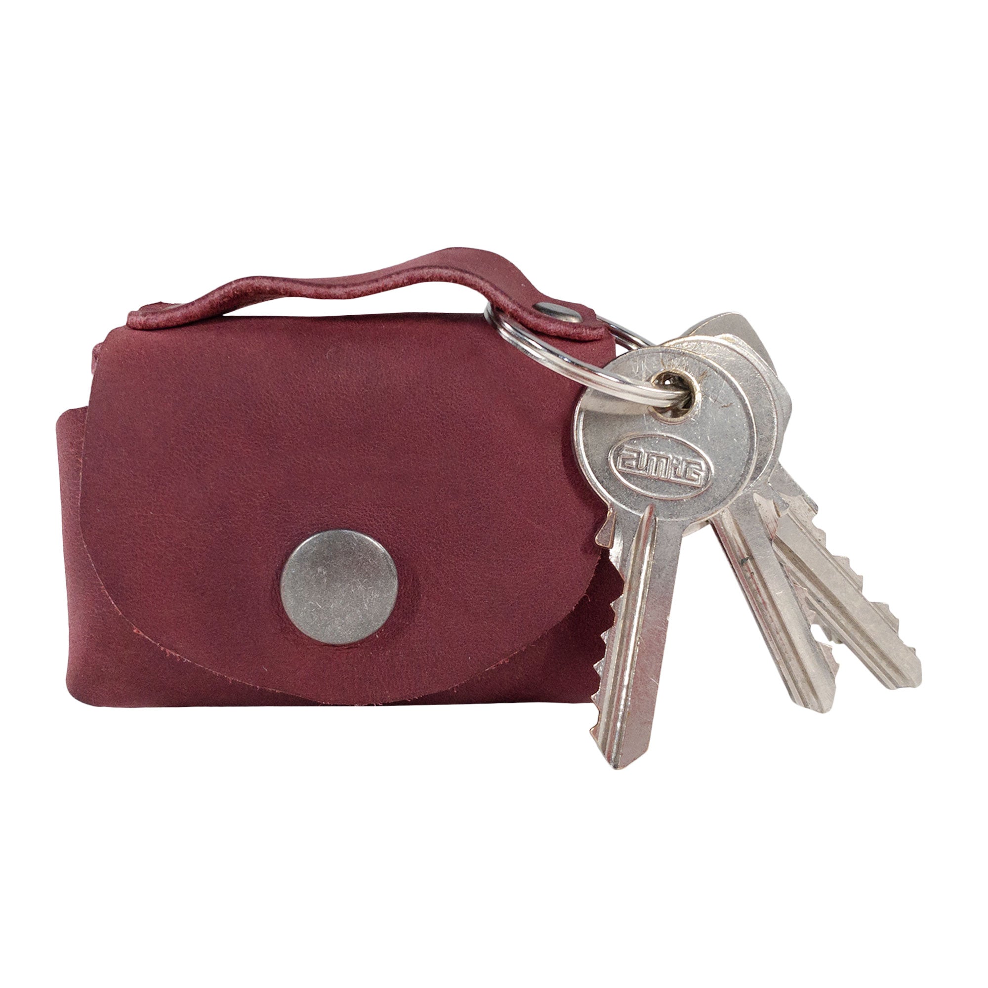 Front view of the Tiny Handbag Keychain by Hide & Drink, featuring a key ring and finished with a stunning Full Grain Leather exterior. This artisan piece highlights the quality of small batch production, reflected in its hand cut and hand sewn details in La Antigua Guatemala.