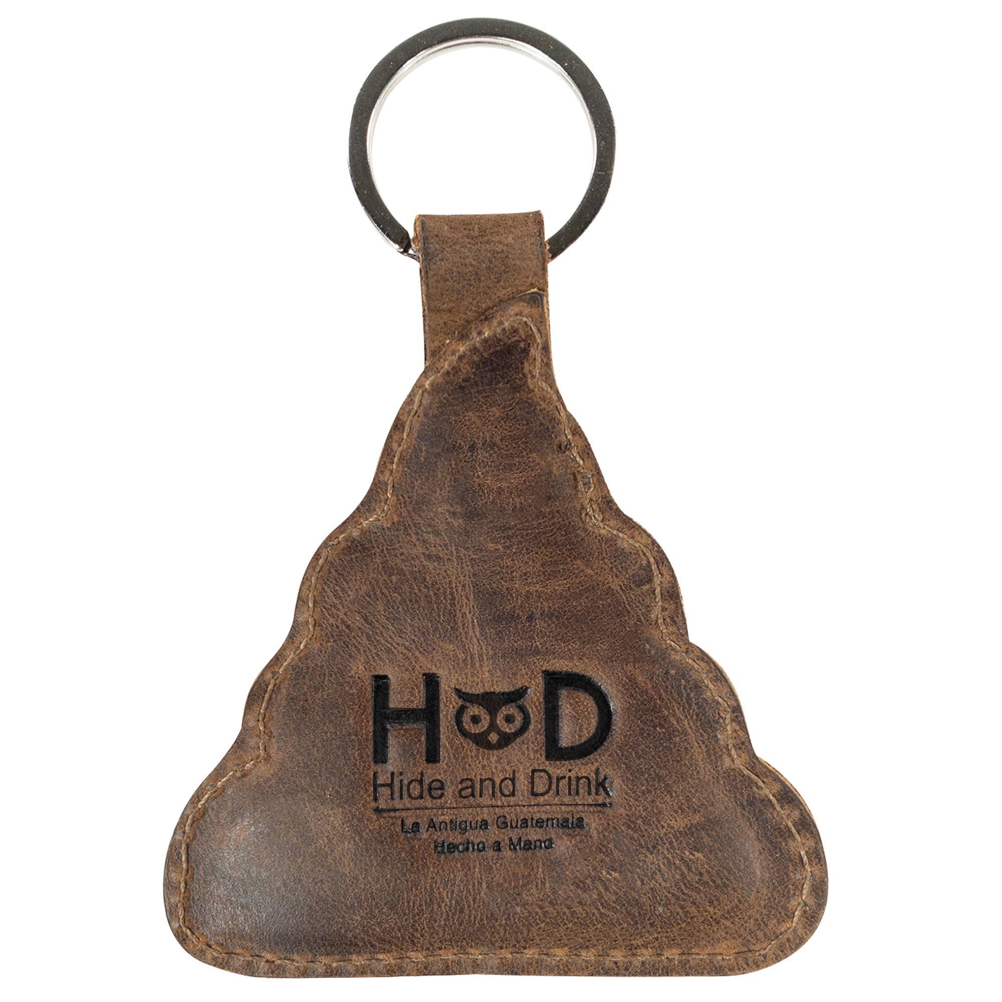 The back view of the Poop Emoji Keychain from Hide & Drink, featuring a clear fire brand logo. This whimsical leather key ring adds a touch of fun to your accessories and makes for great gifts. Constructed from Full Grain Leather, it reflects the spirit of StockyardX’s Small Batch Production with the artisan's hand-cut and hand-sewn techniques. Handmade in La Antigua Guatemala & Oaxaca Mexico.