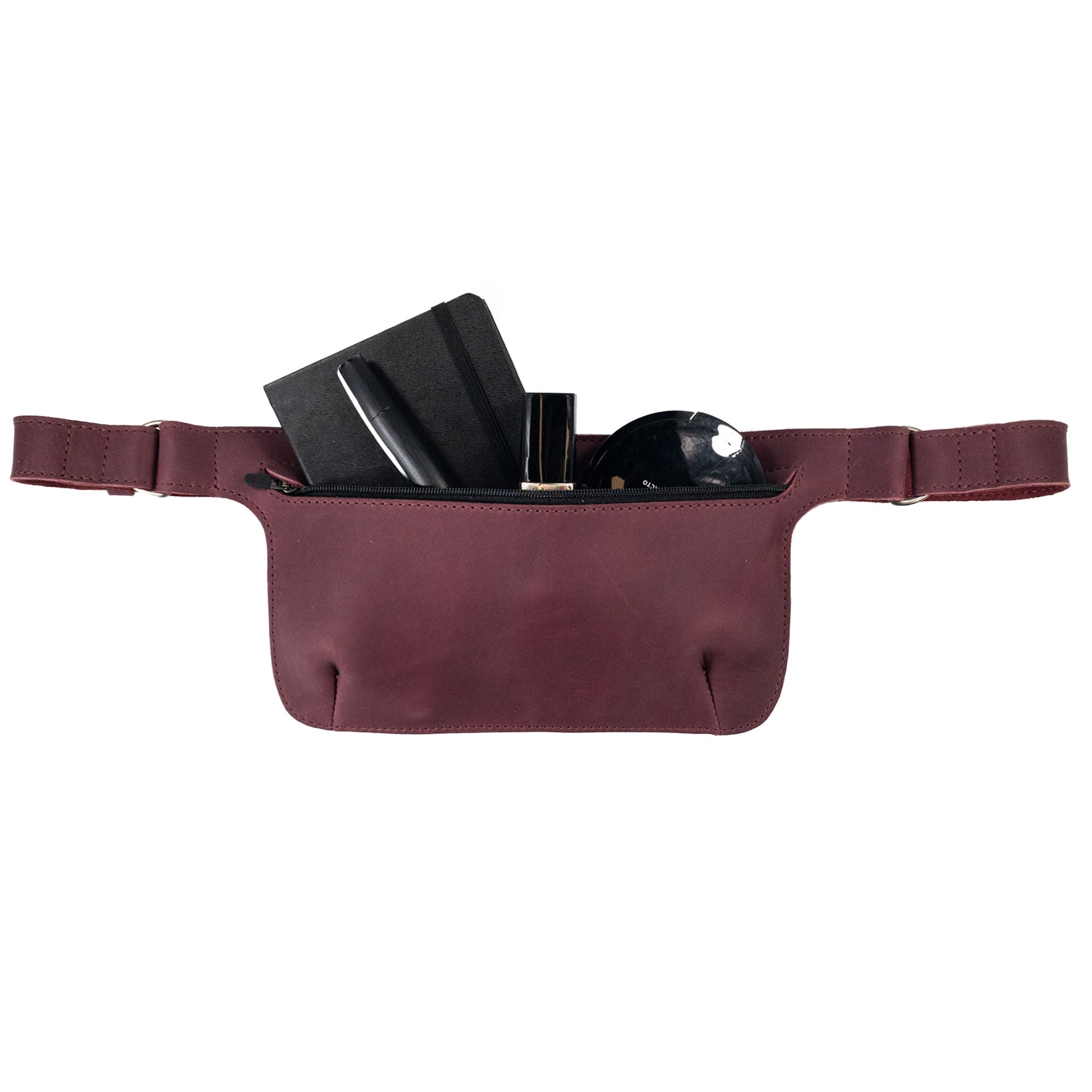 Slim Fanny Pack by Hide & Drink showcasing a color contrast in a maroon leather finish, ideal for a trendy phone holder. This handmade accessory is crafted from full grain leather and reflects artisan craftsmanship.