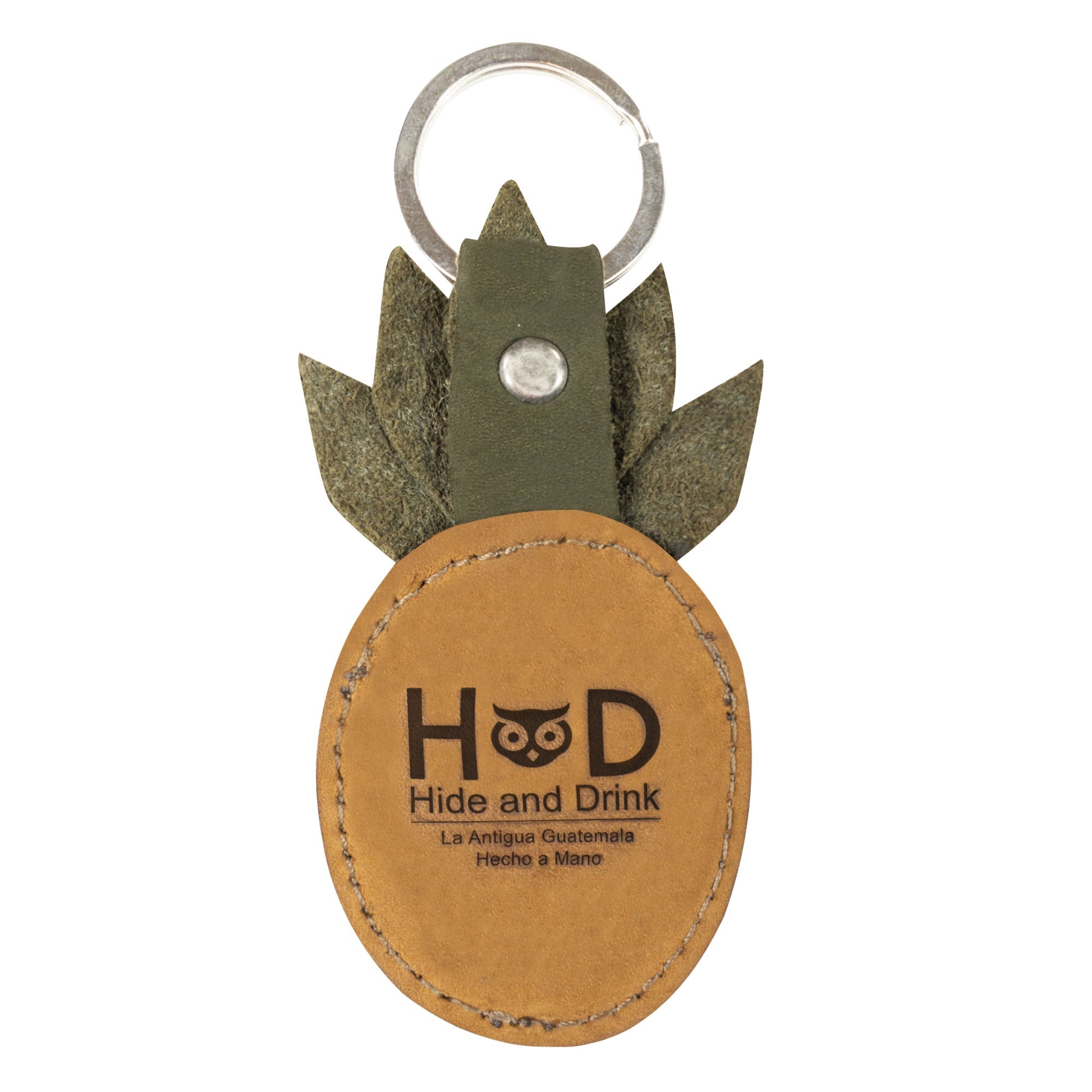 The Pineapple Keychain by Hide & Drink features a unique design with a logo that emphasizes its artisanal quality. Handcrafted from full grain leather, this tropical fruit-inspired key ring combines functionality with style, making it a charming addition to your accessory collection.