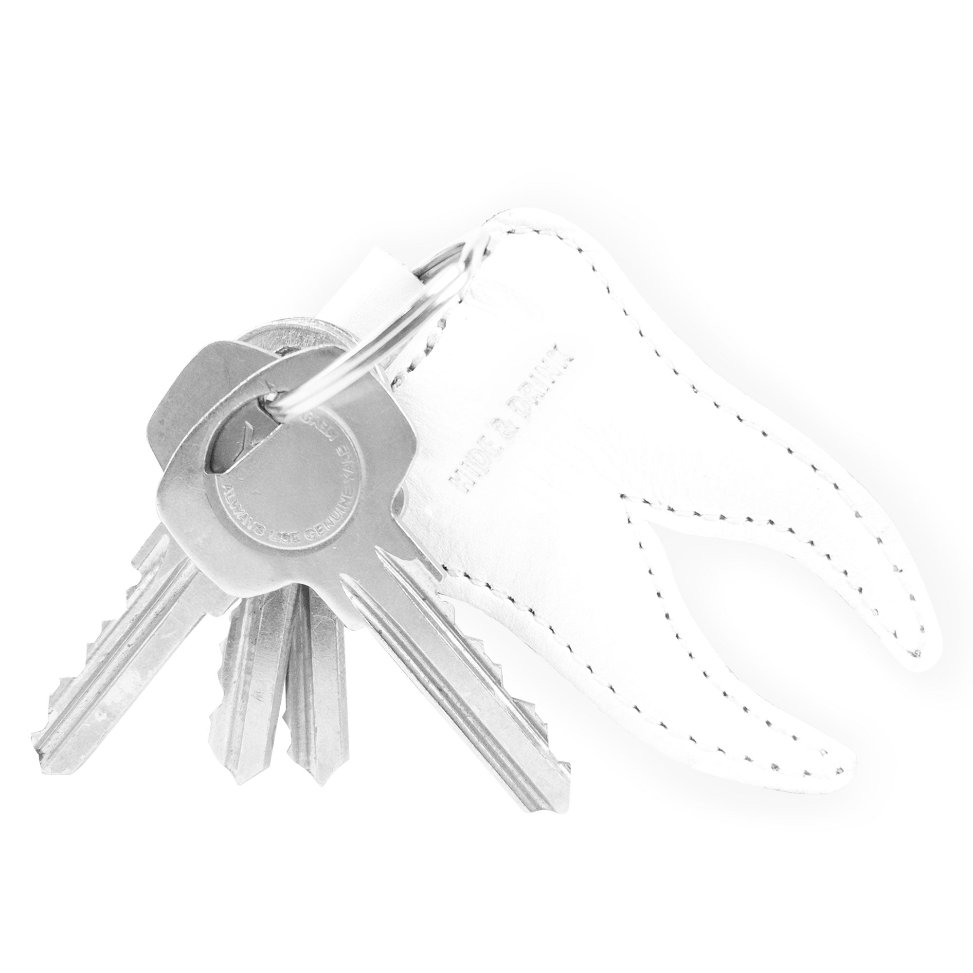 Another angle of the Tooth Keychain by Hide & Drink, highlighting its playful design for those in the dental field. This Tooth Leather Keychain is crafted from full grain leather and is an excellent key ring for dentist gifts or for celebrating the Tooth Fairy, reflecting artisan, handmade quality from Guatemala and Mexico.
