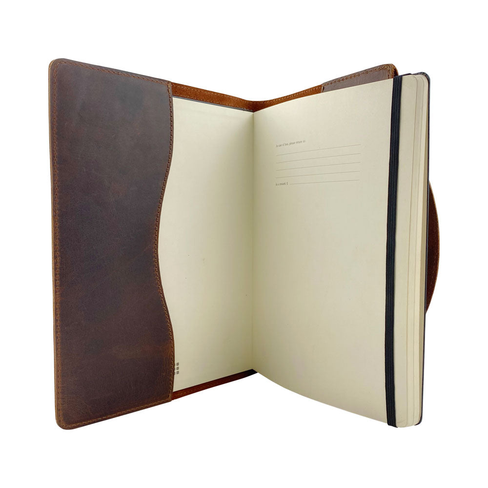 A distinct presentation of the Hard Cover Notebook Protector (Notebook NOT Included) by Hide & Drink, showing off its richness. Ideal for Moleskine Hard Cover Sketchbook XXL Size (8.5 x 11 in.), Notebook NOT Included, this journal cover is produced using high-quality Full Grain Leather, showcasing StockyardX’s commitment to small batch production with hand cut, hand sewn, and fire branded craftsmanship by artisans. Handmade in La Antigua Guatemala & Oaxaca Mexico.