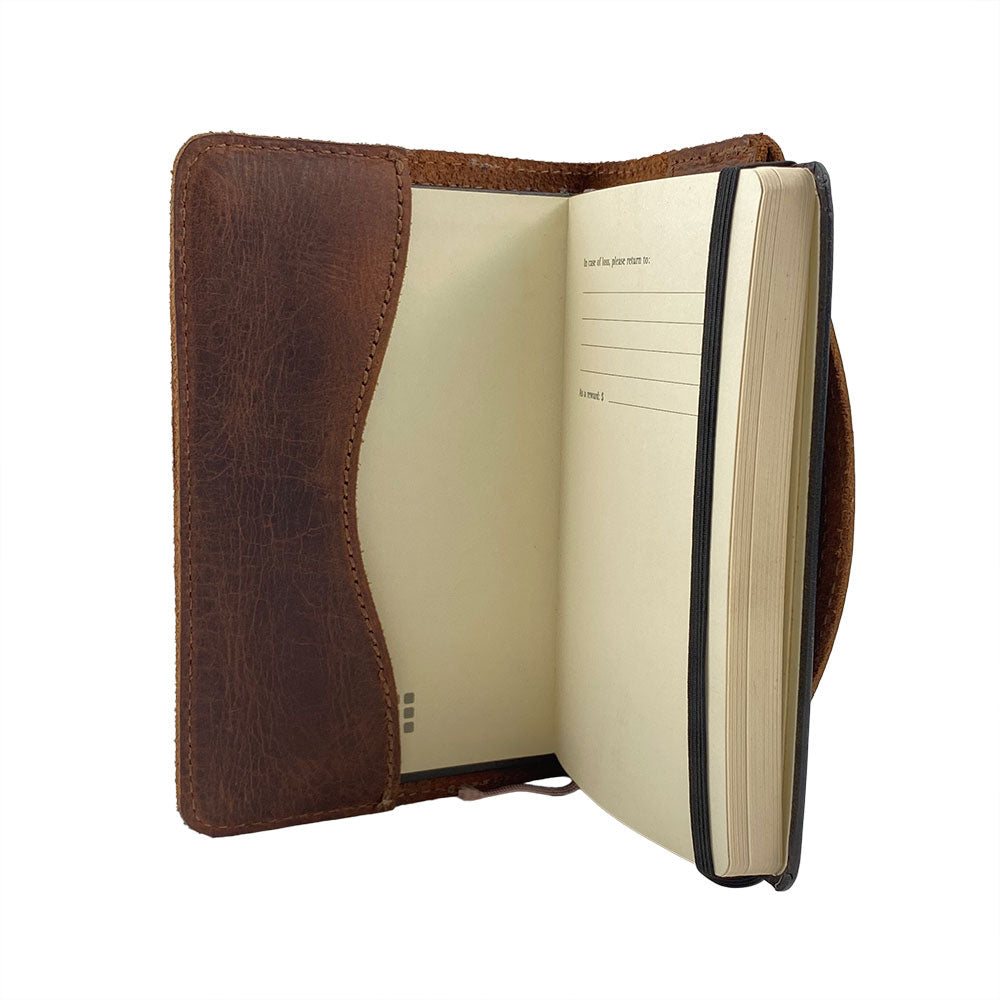 An aesthetically pleasing side view of the Hard Cover Notebook Protector (Notebook NOT Included) by Hide & Drink, exhibiting its quality details. This journal cover works for Moleskine Hard Cover Sketchbook XXL Size (8.5 x 11 in.), Notebook NOT Included, utilizing Full Grain Leather from StockyardX—characterized by small batch production and careful hand cut, hand sewn, and fire branded artisan craftsmanship. Handmade in La Antigua Guatemala & Oaxaca Mexico.