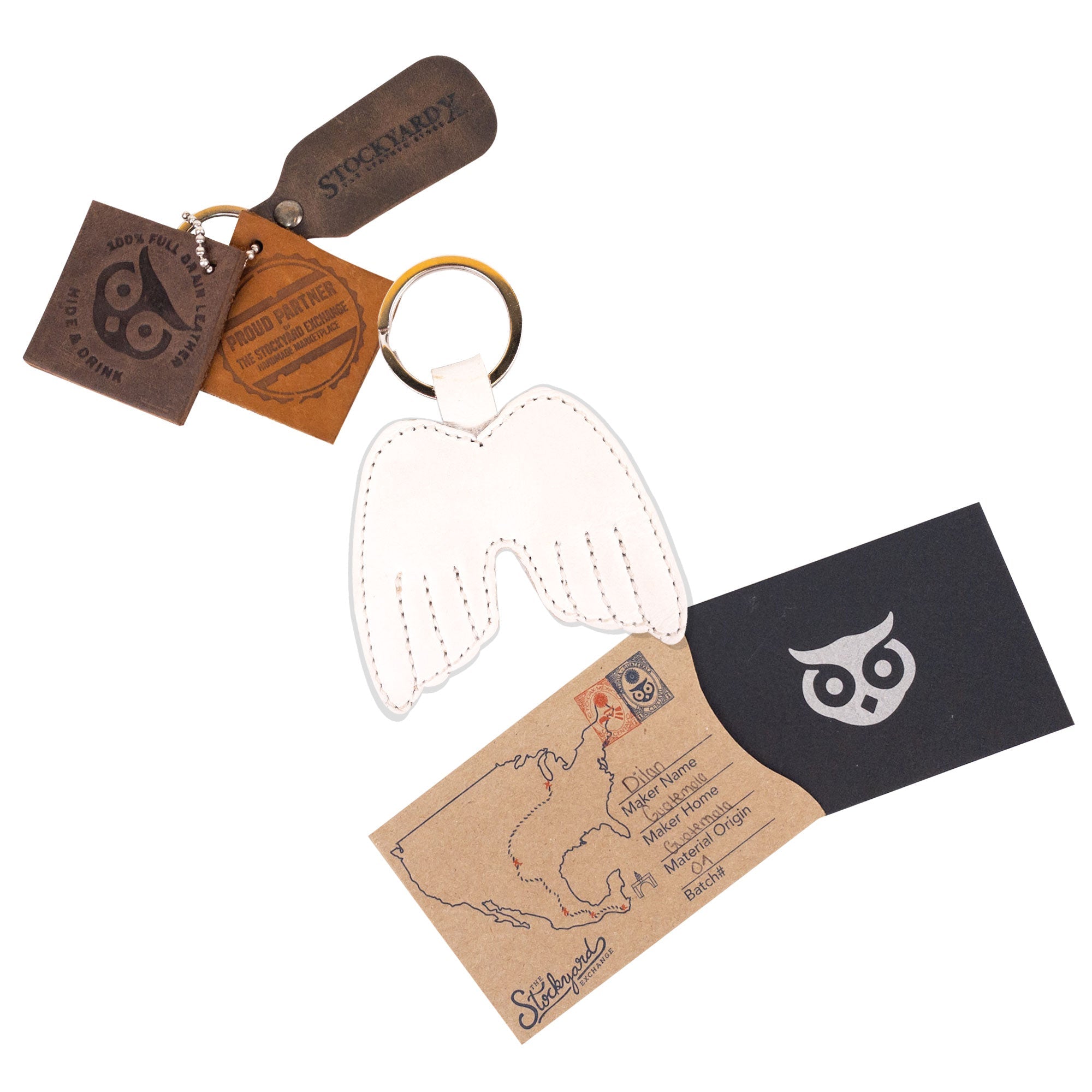 Angel Wings Keychain by Hide & Drink presented with its packaging, demonstrating the Full Grain Leather key holder’s artisanal quality. This unique accessory showcases a peaceful wing design and represents small batch production. Handmade in La Antigua Guatemala & Oaxaca Mexico, it is hand-cut and hand-sewn, with a fire branded touch from skilled artisans.